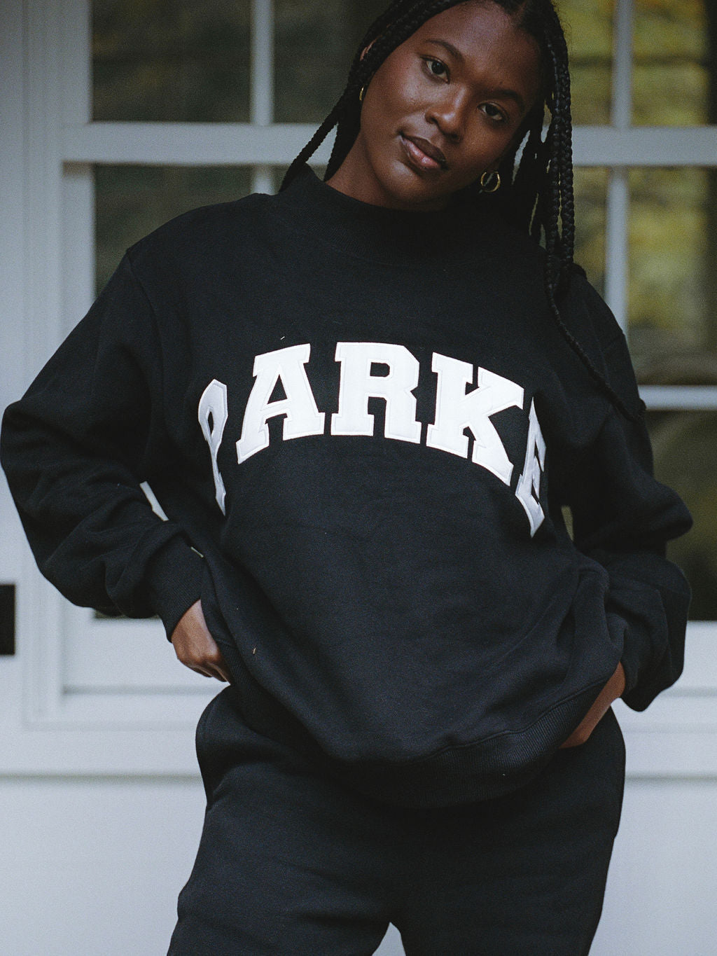 model wearing black varsity mockneck -black + white