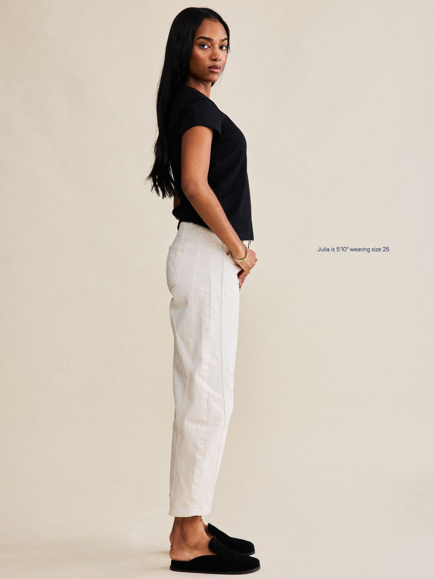 girl wearing horseshoe jeans -cream