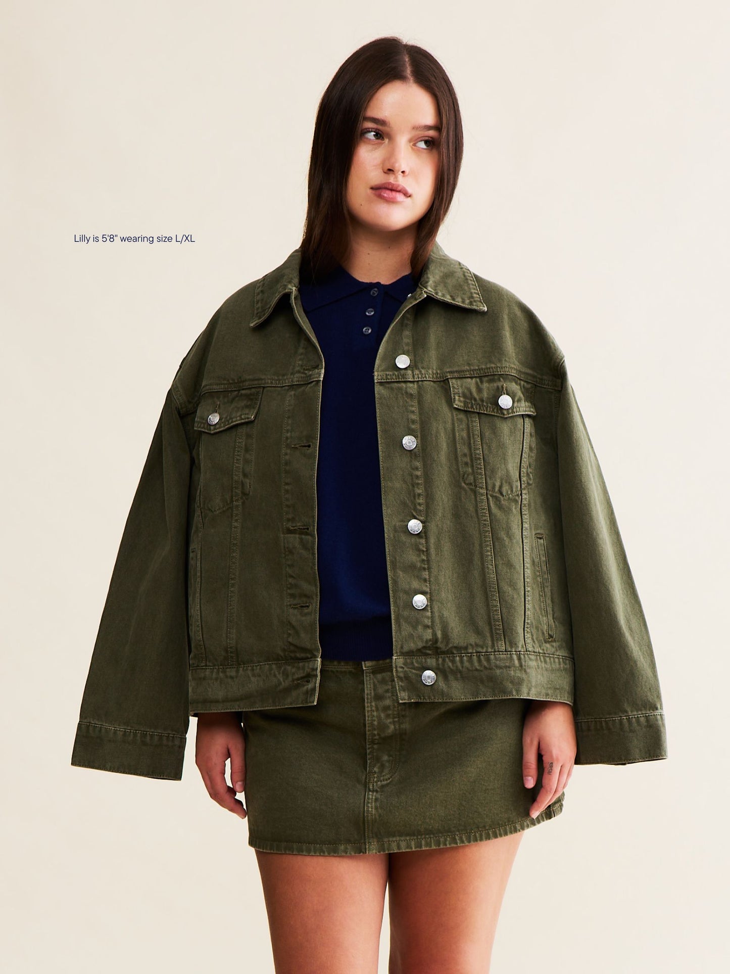 vintage wash girl wearing oversized denim jacket -olive