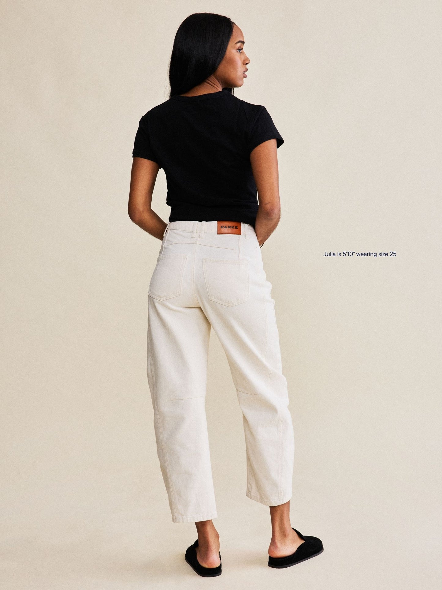 girl wearing horseshoe jeans -cream