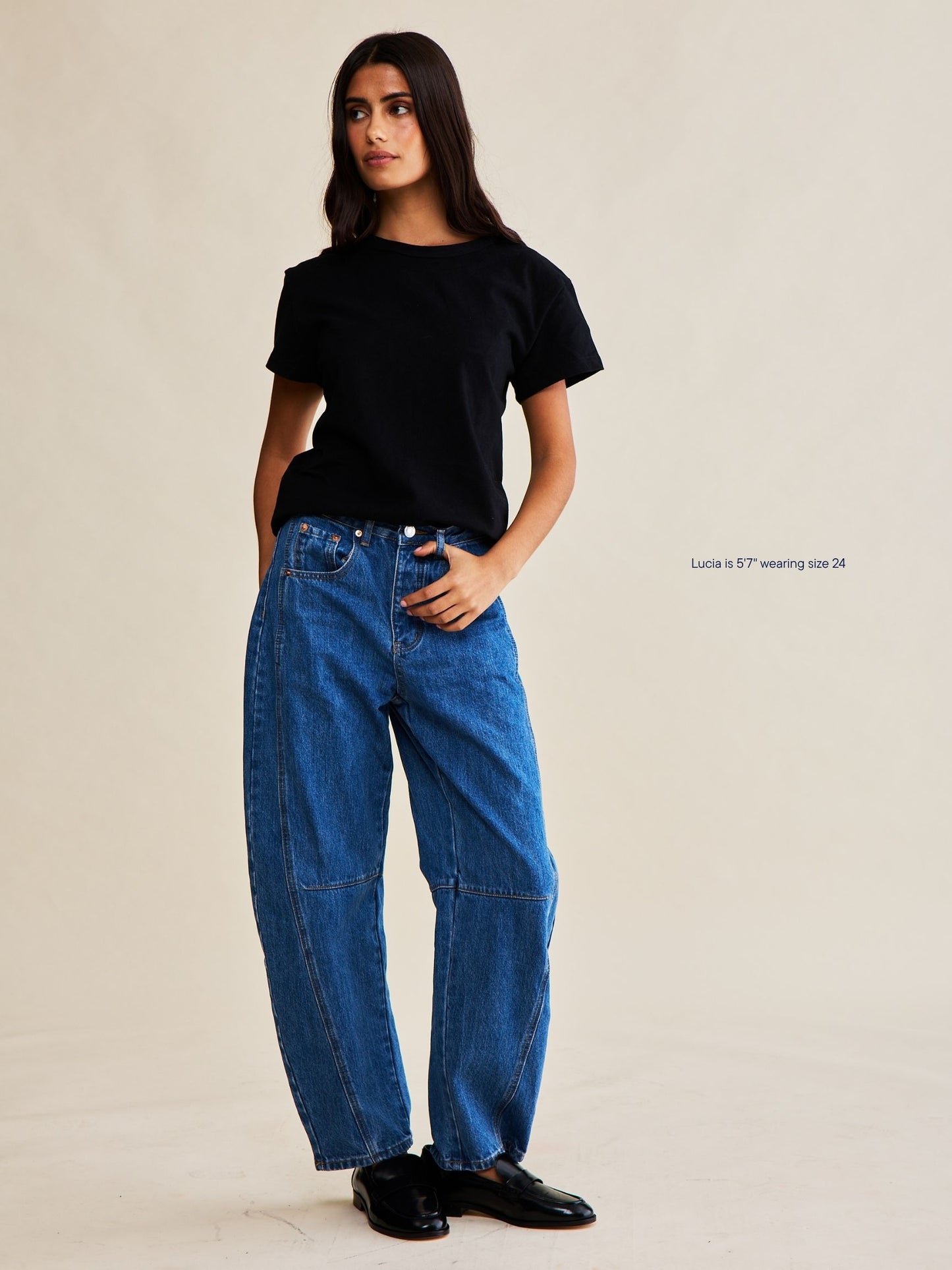 girl wearing horseshoe jeans -medium wash