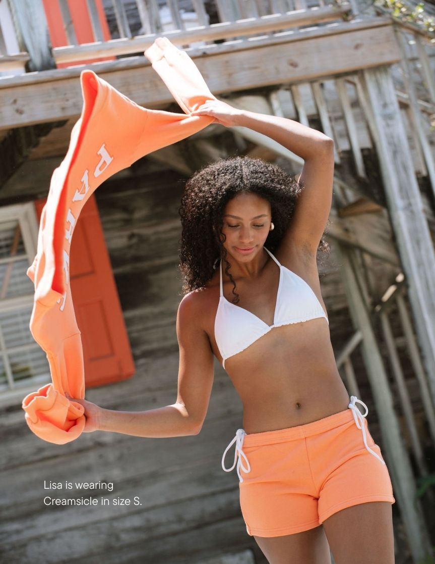 girl wearing heritage mini sweatshorts -orange