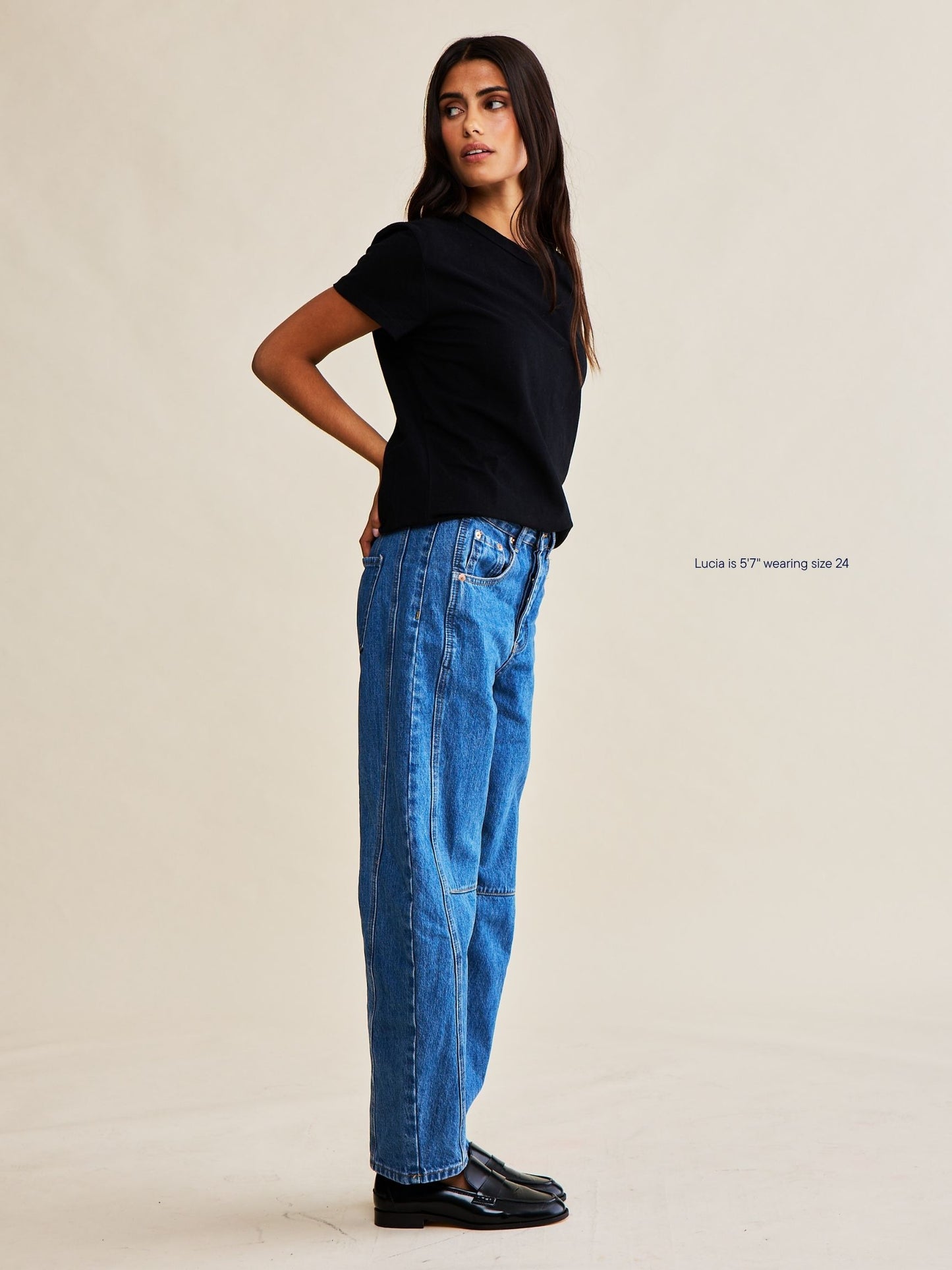 girl wearing horseshoe jeans -medium wash