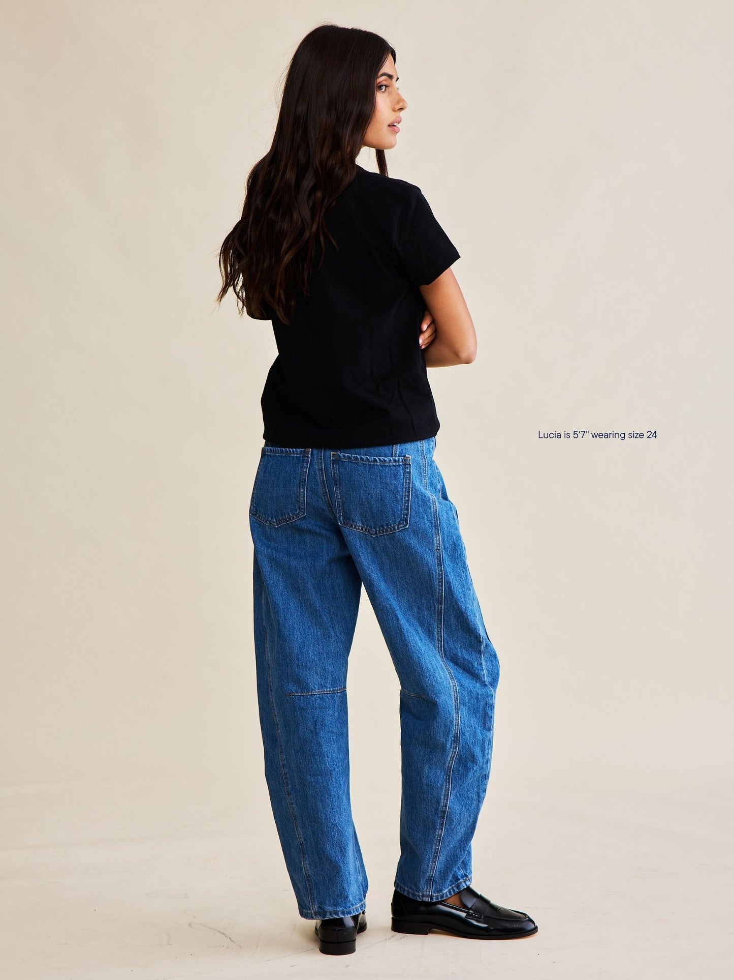 girl wearing horseshoe jeans -medium wash