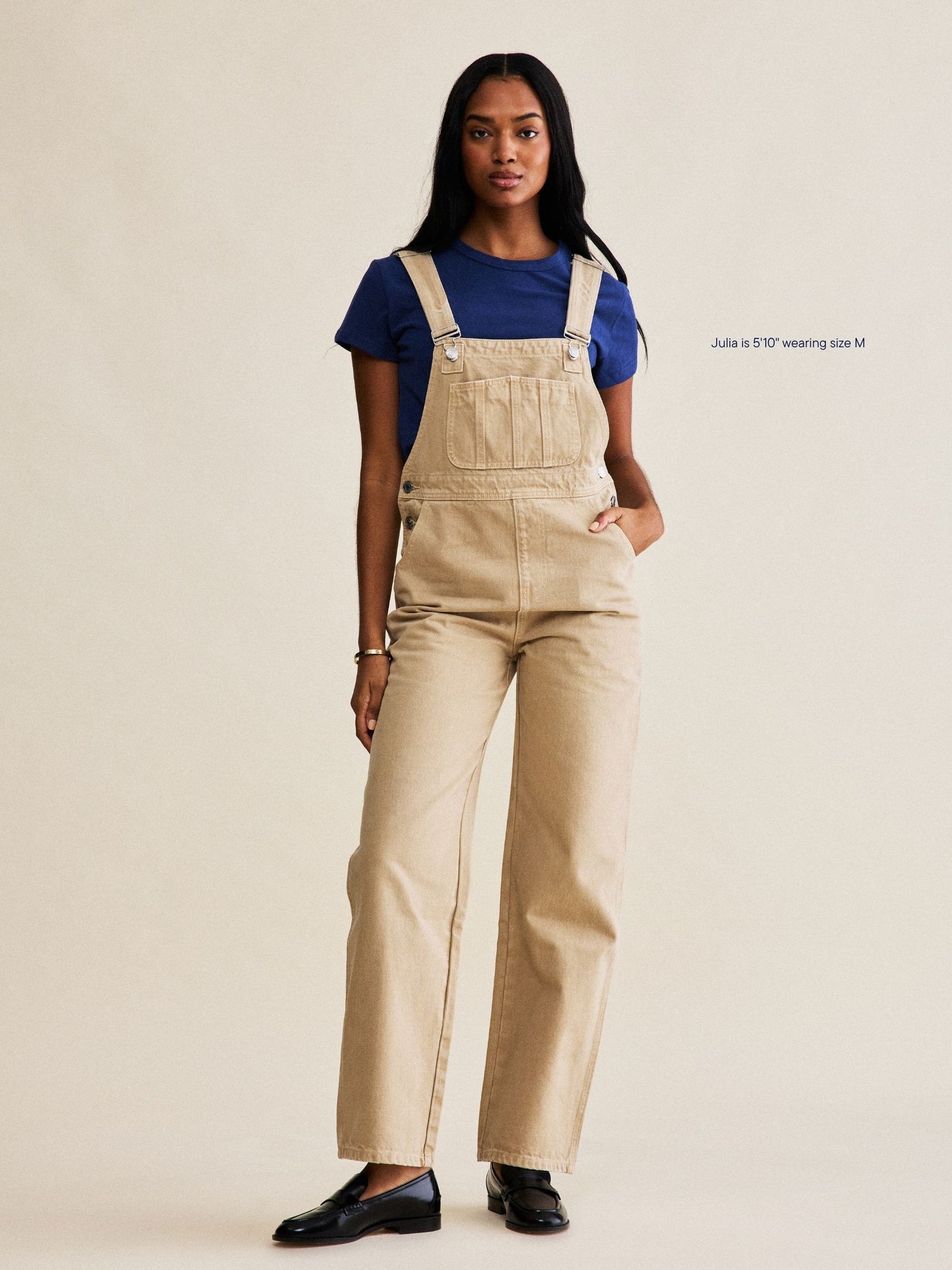 denim overalls flat lay -camel