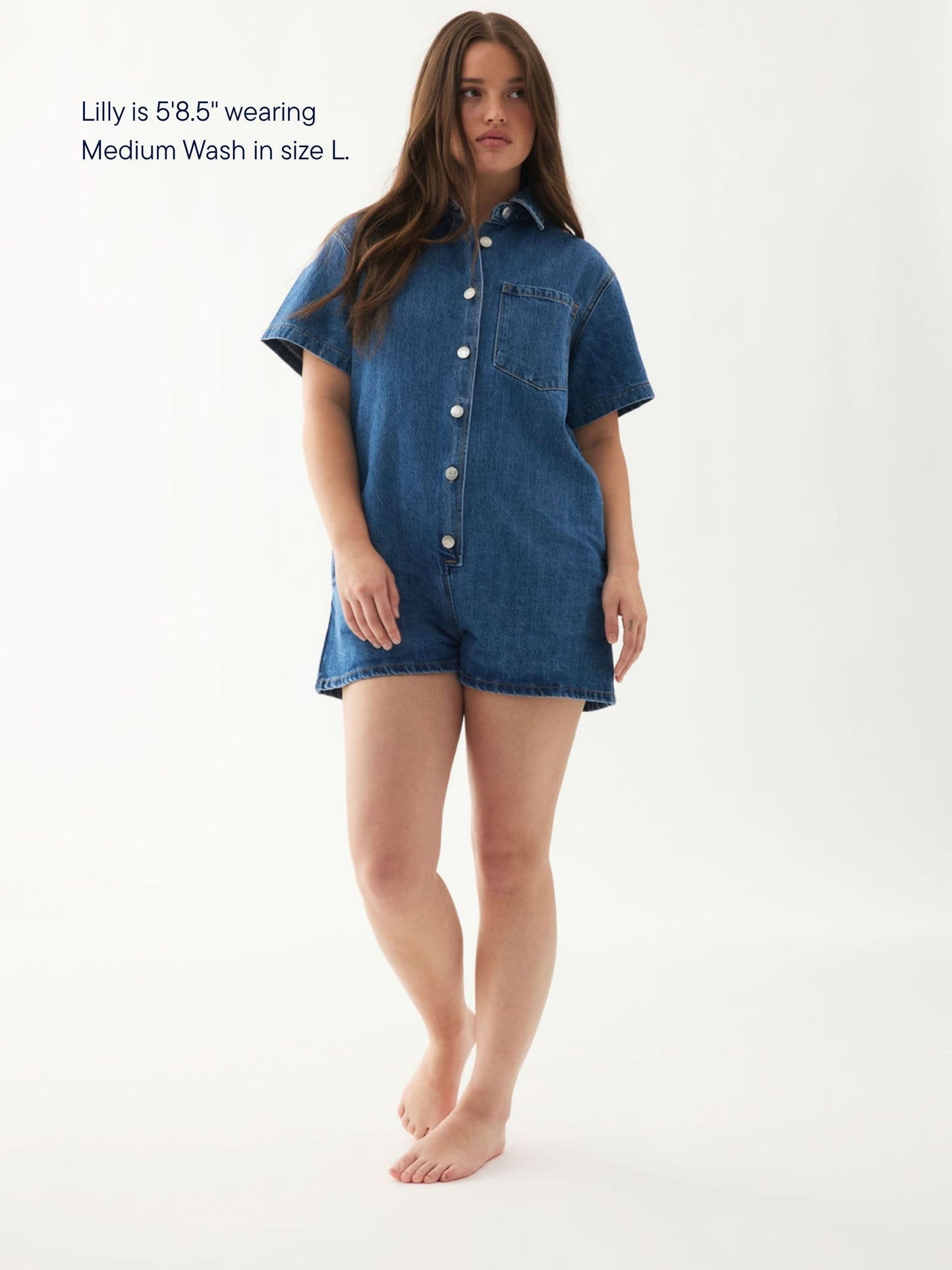 girl wearing short sleeve denim romper -medium wash