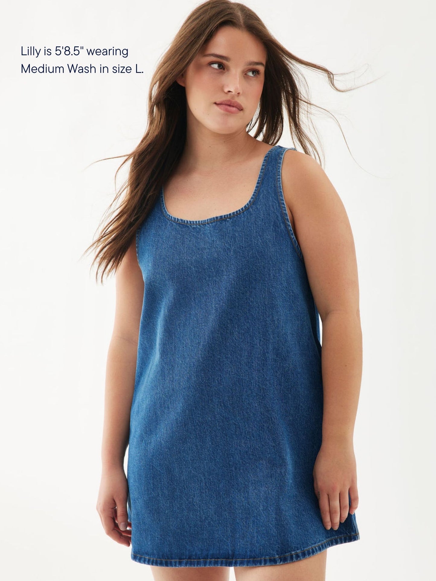 girl wearing denim mini dress -medium wash