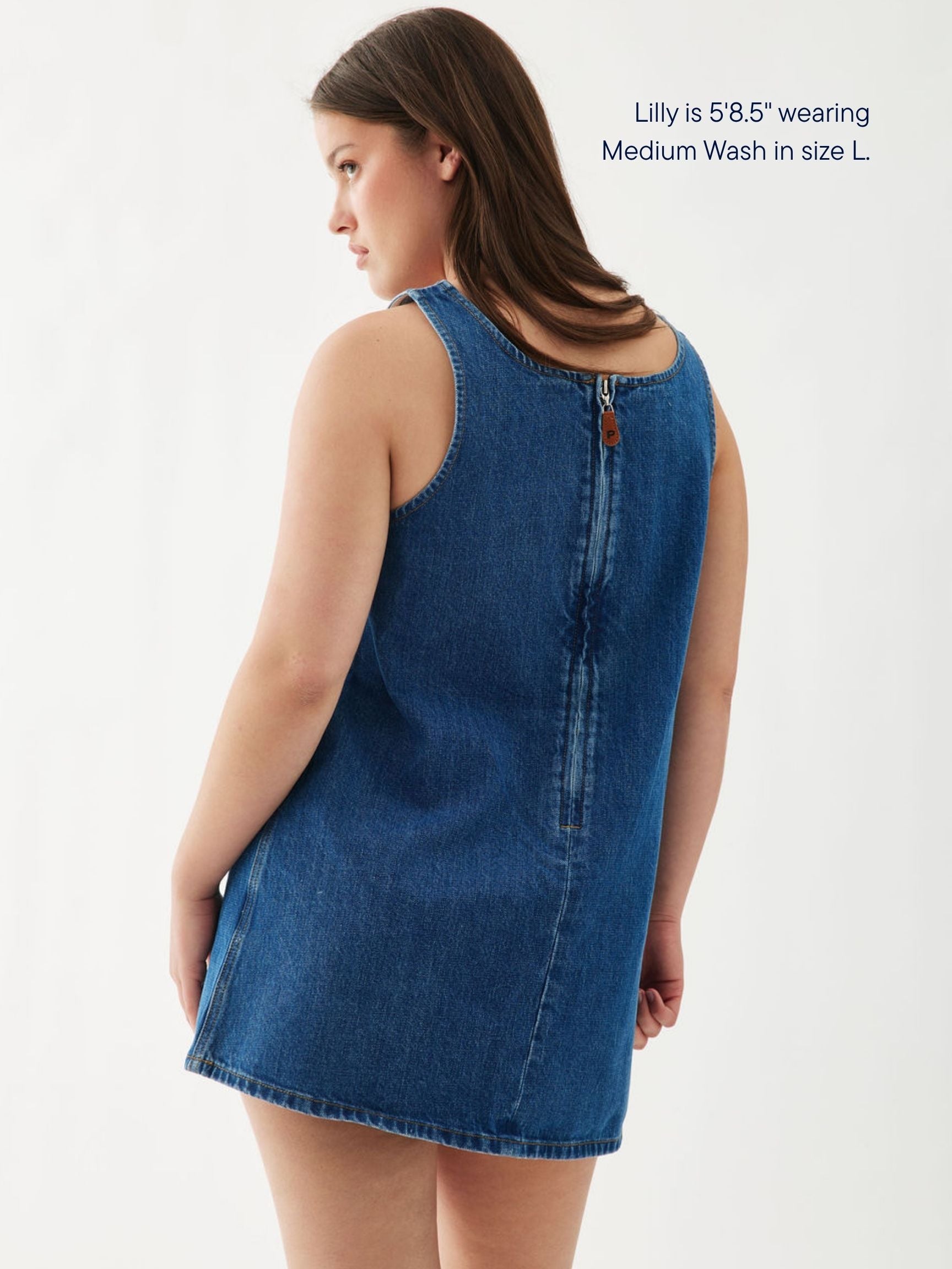 girl wearing denim mini dress -medium wash