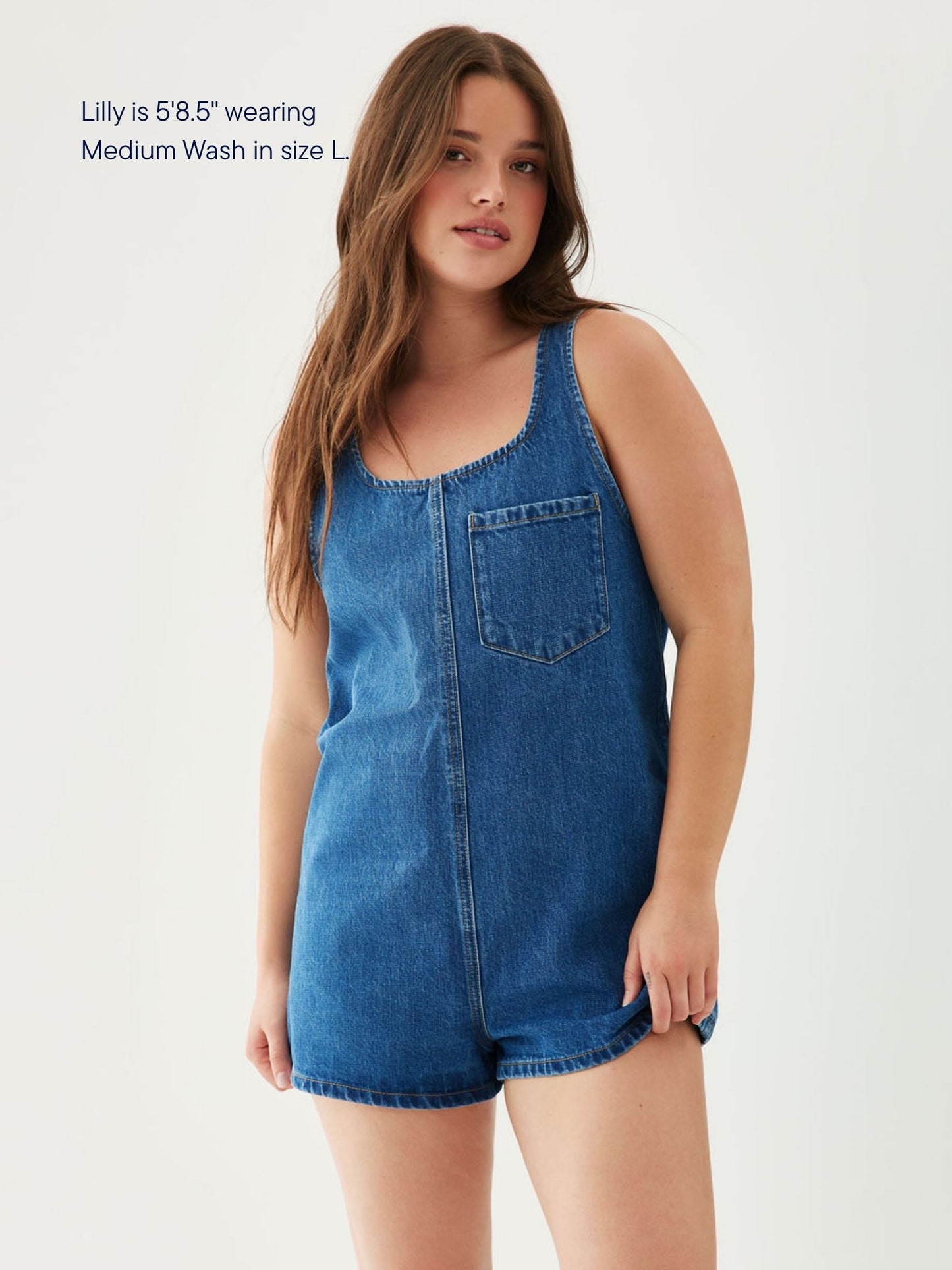 girl wearing tank top denim romper -med wash