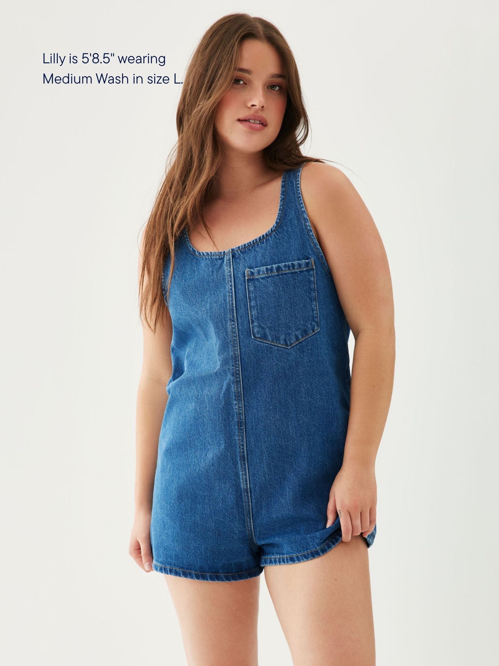 girl wearing tank top denim romper -med wash