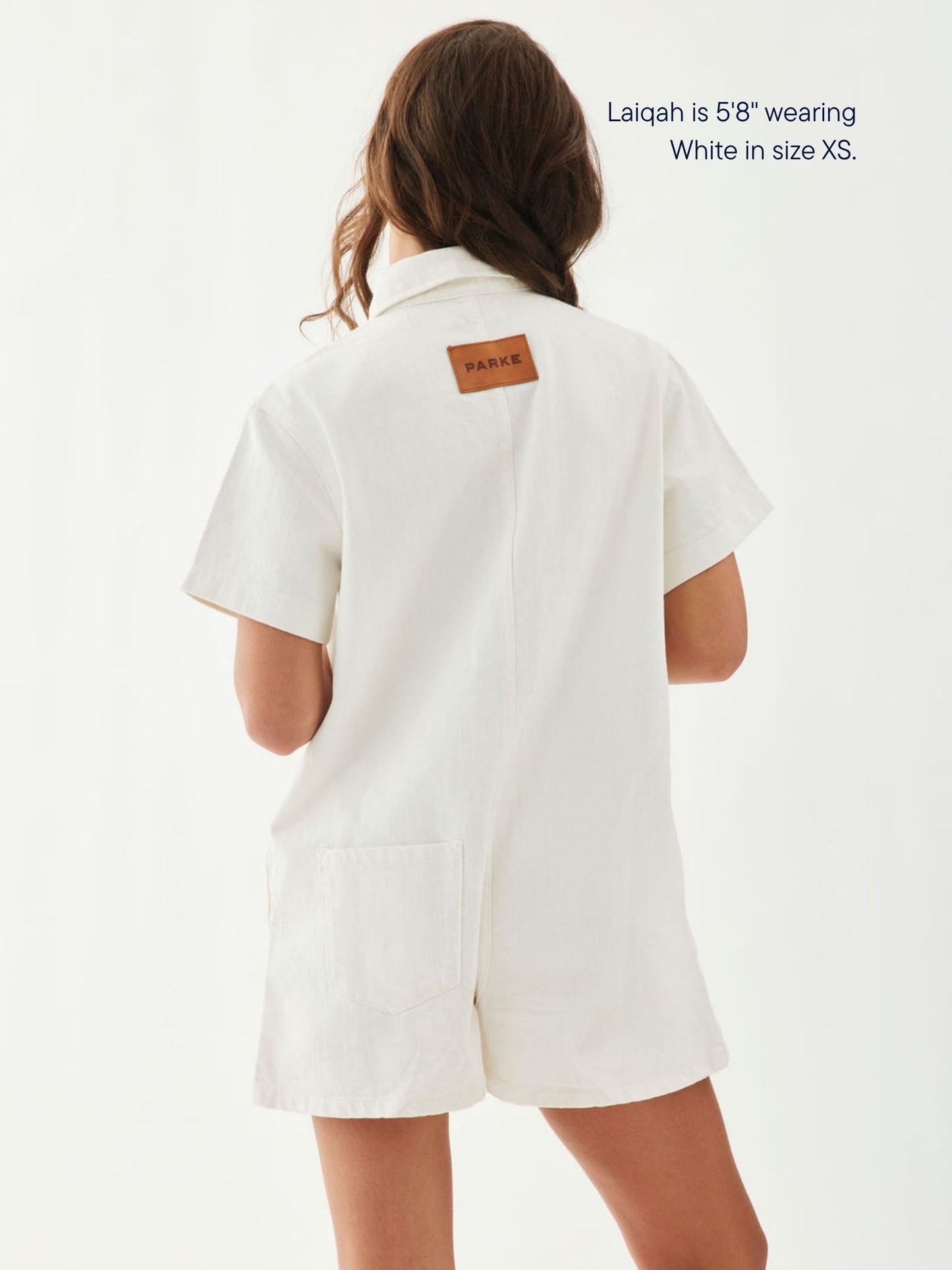 girl wearing short sleeve denim romper -white