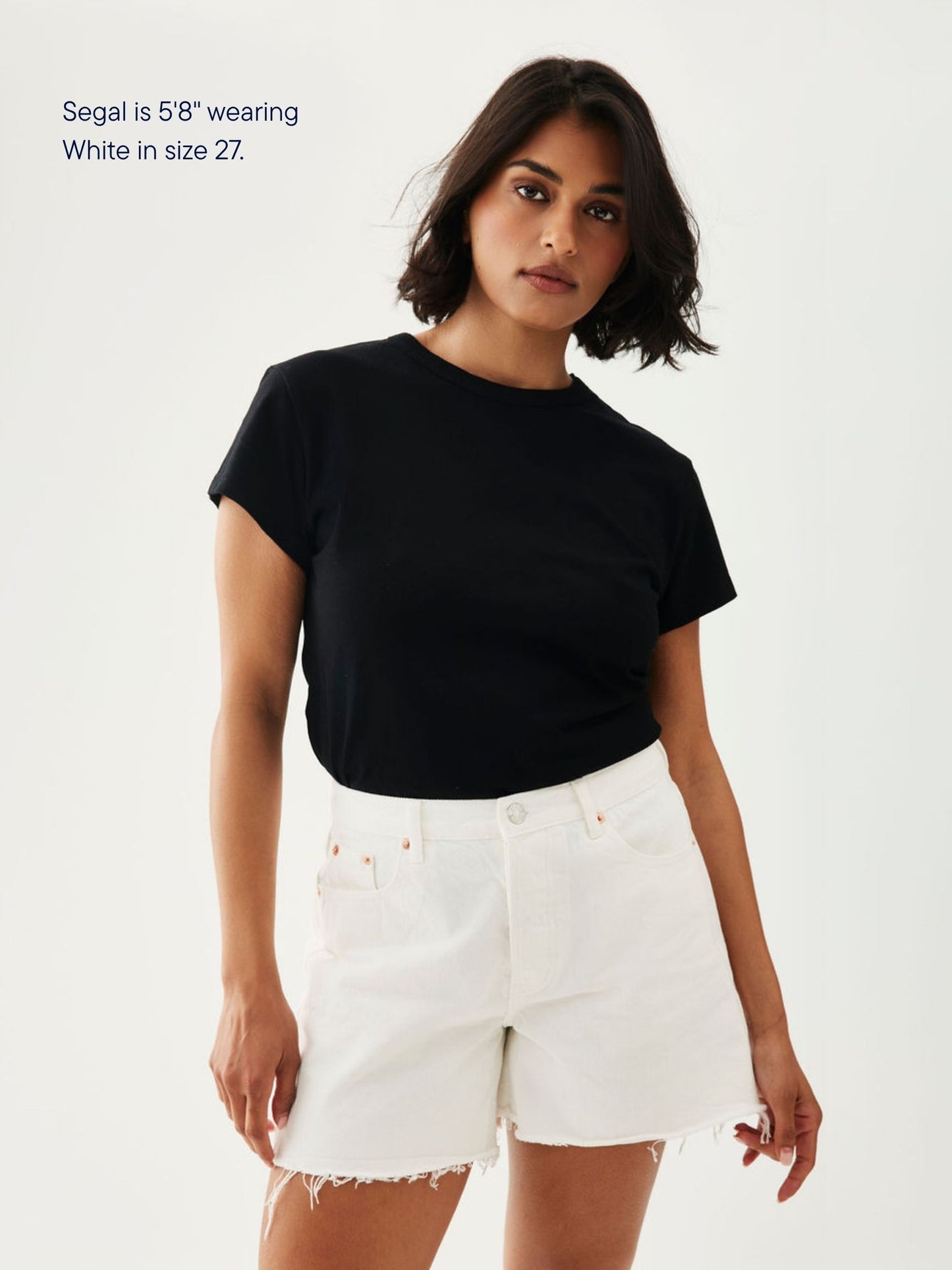 girl wearing long baggy shorts -white