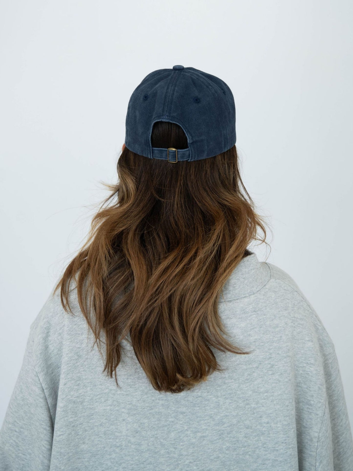 girl wearing flower hat back -navy