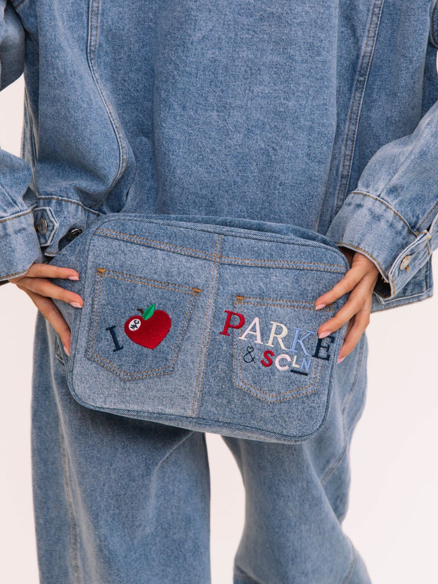 girl holding SCL x Parke Large Pouch flat -vintage wash