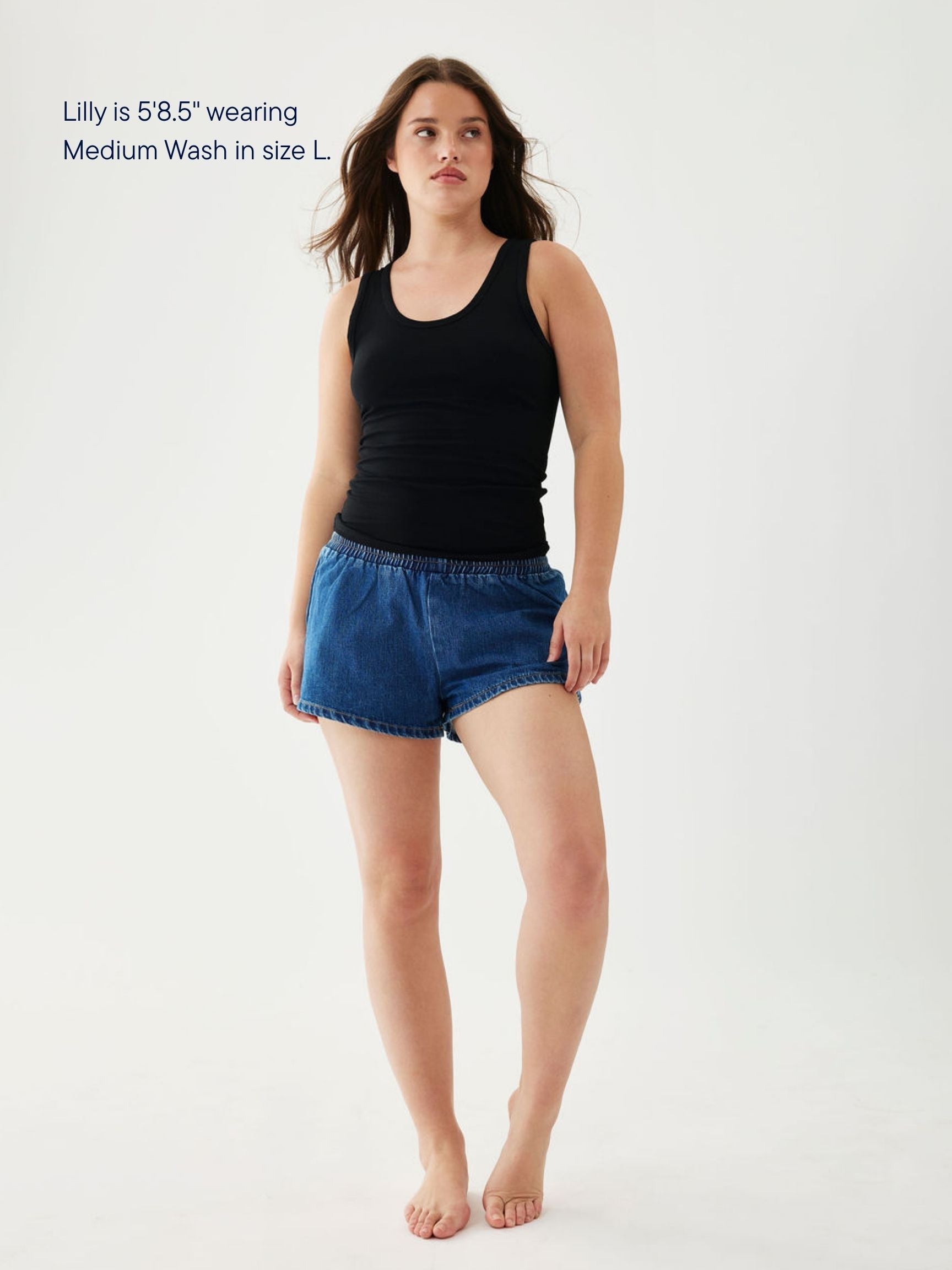 girl wearing elastic denim mini short -medium wash