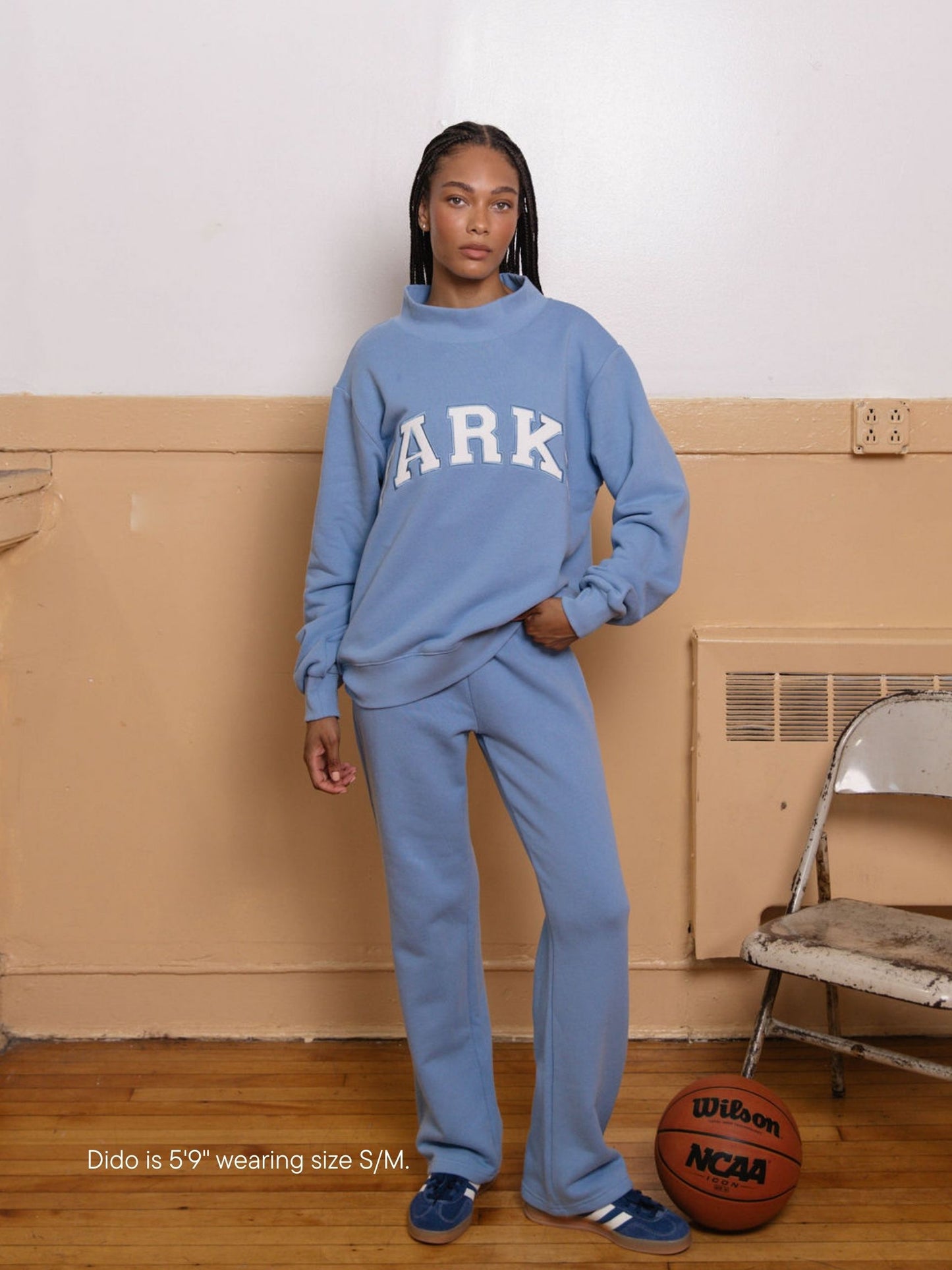 girl wearing back to school varsity mockneck -sky + white