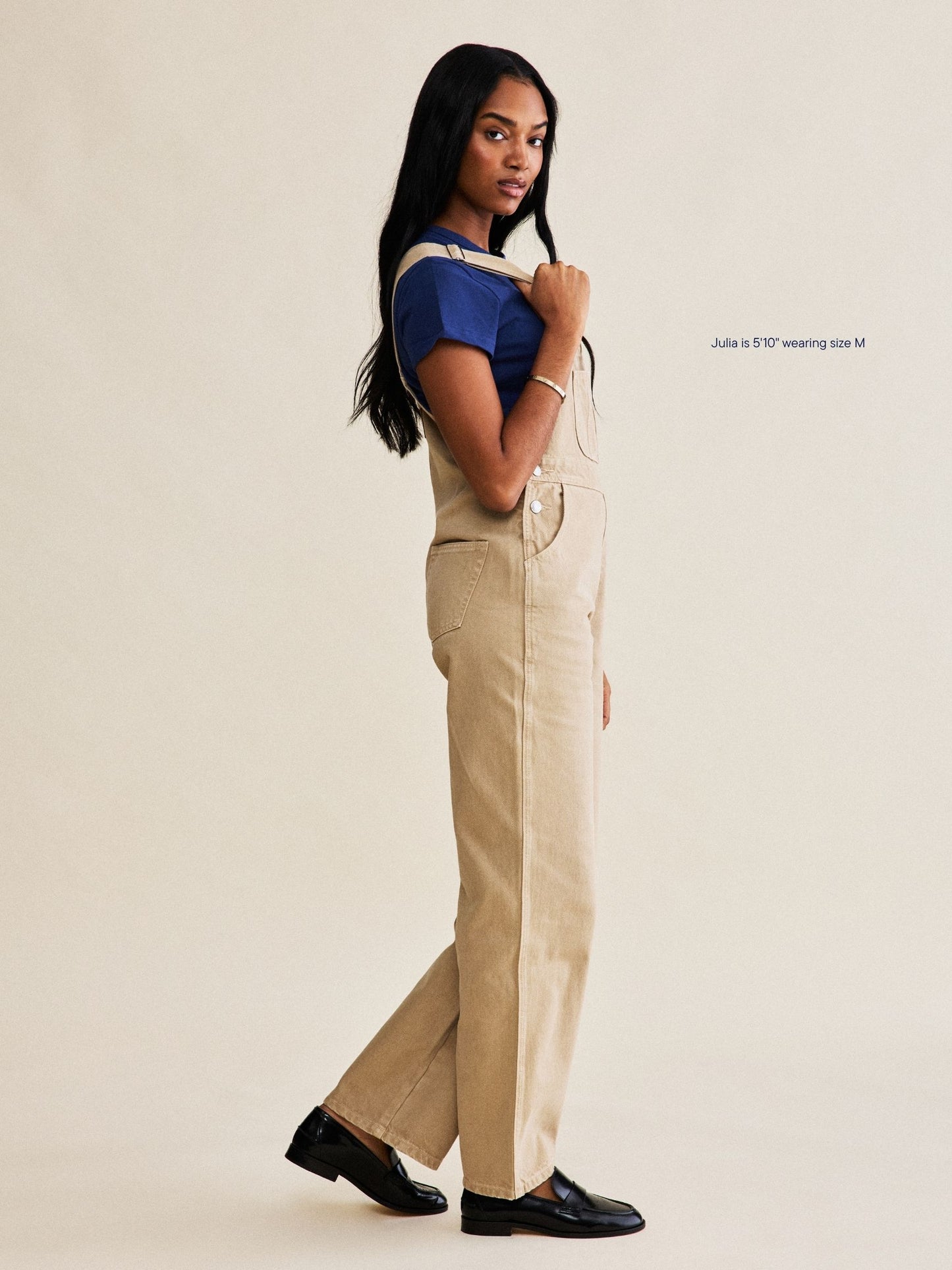 denim overalls flat lay -camel