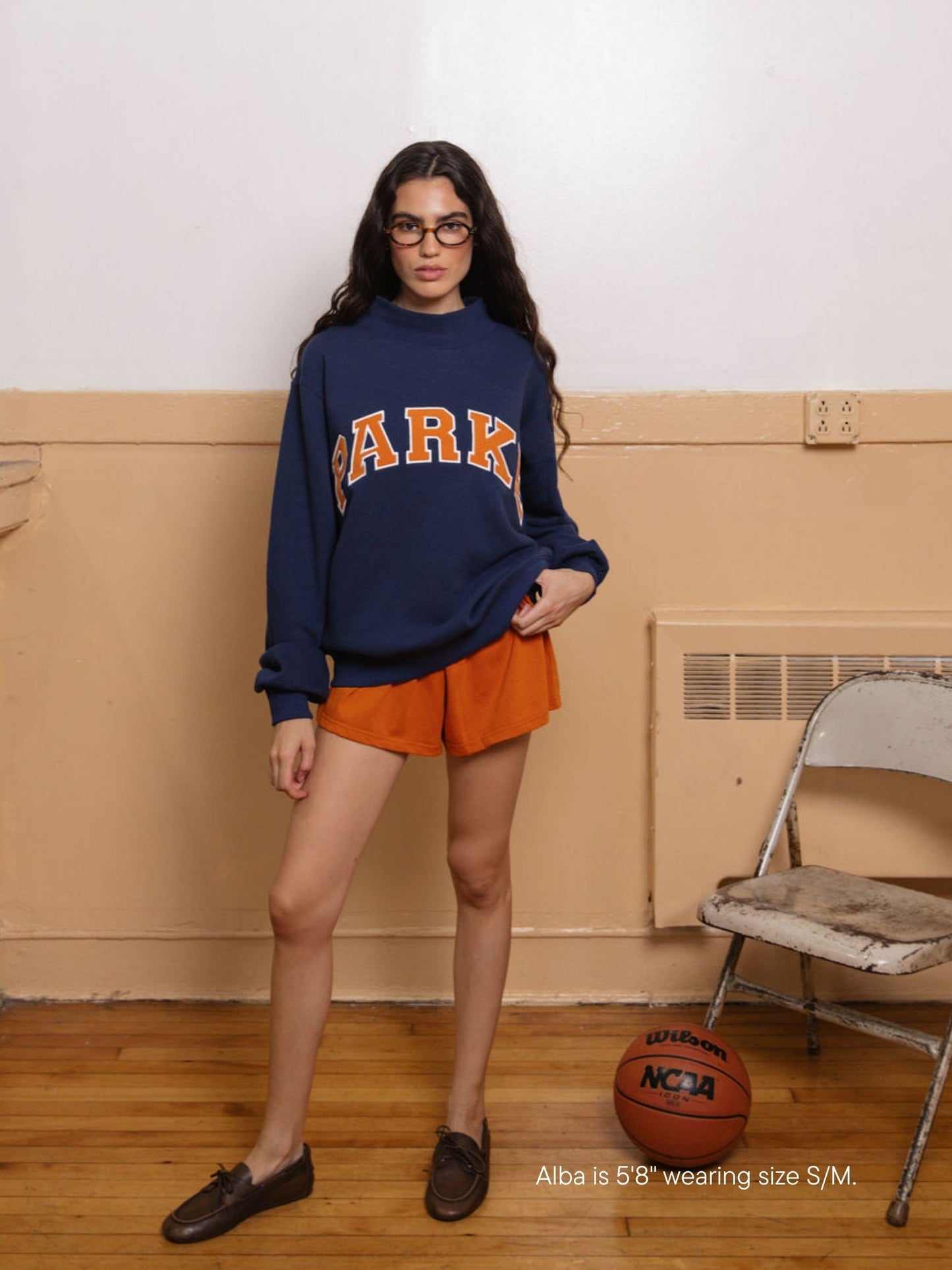 girl wearing back to school varsity mockneck -denim + amber
