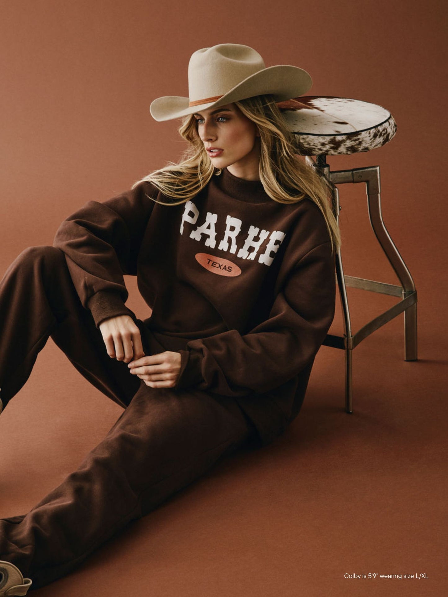 girl wearing Cities Signature Mockneck -cowboy texas