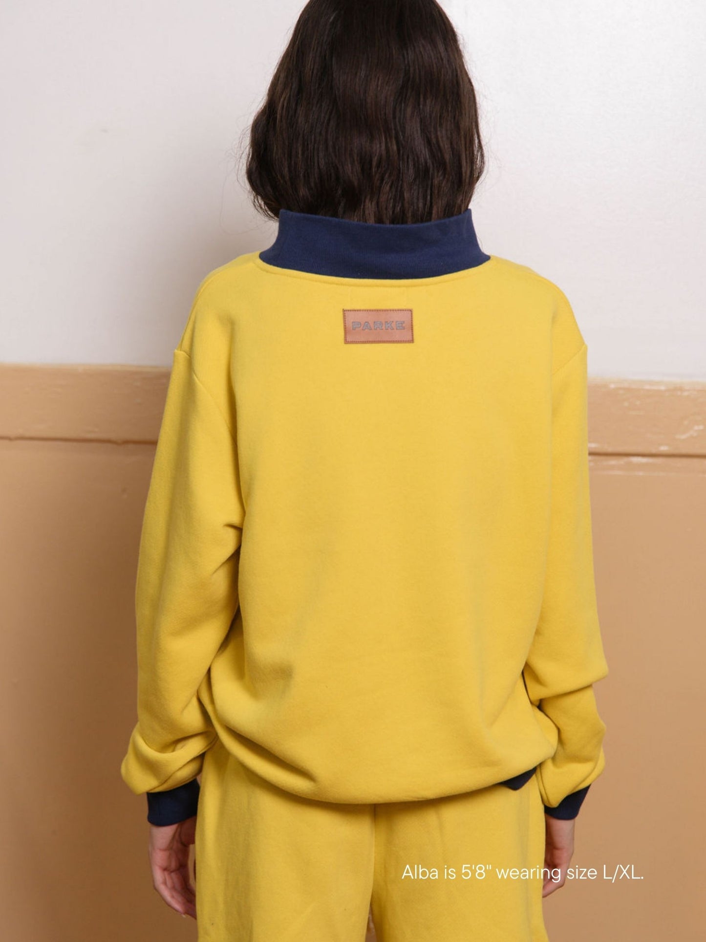 girl wearing two tone classic mockneck -maize + denim
