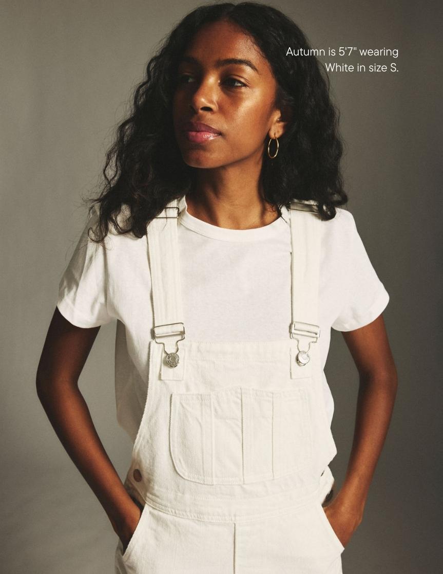 girl wearing denim overalls -white