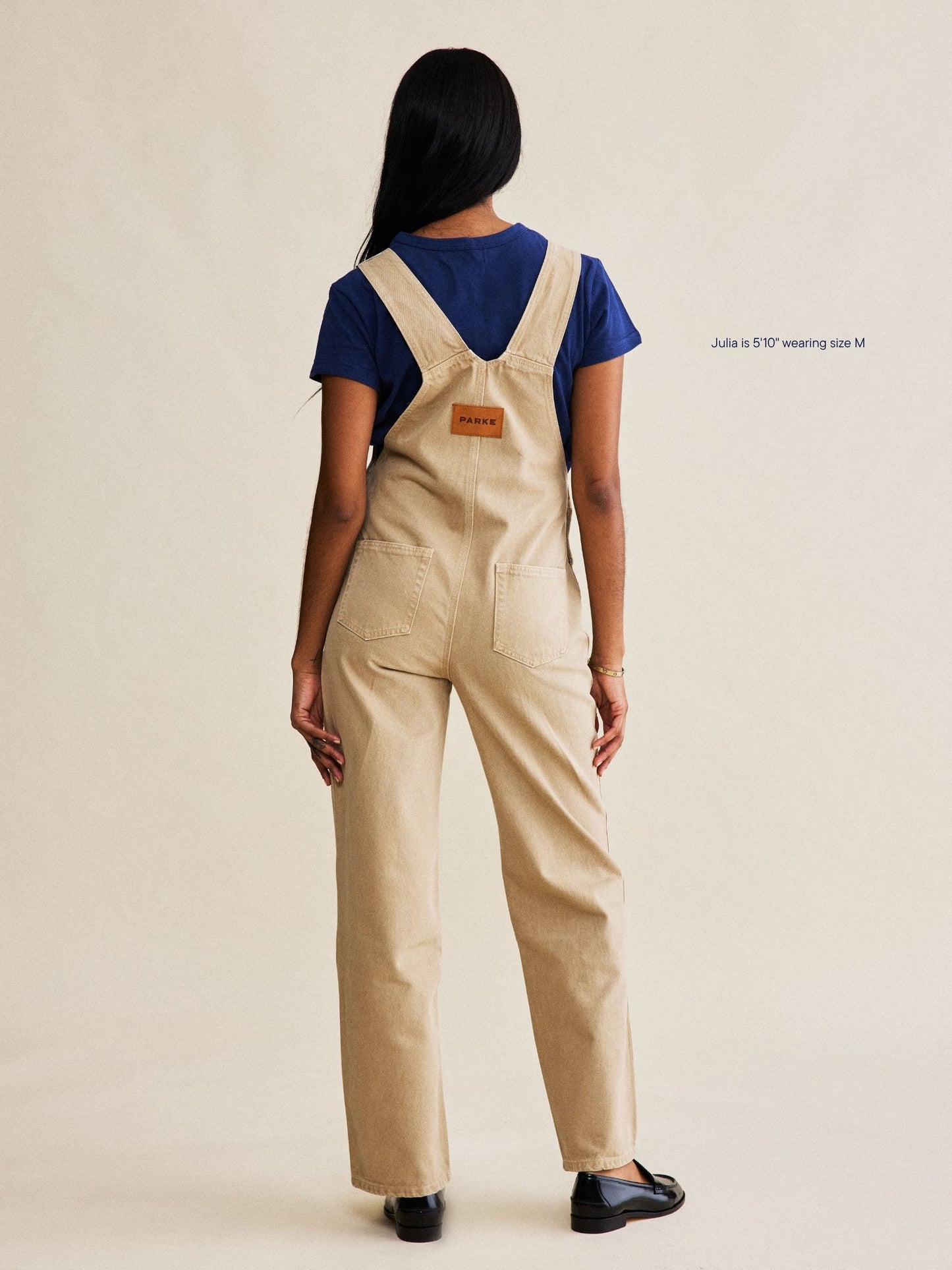 denim overalls flat lay -camel