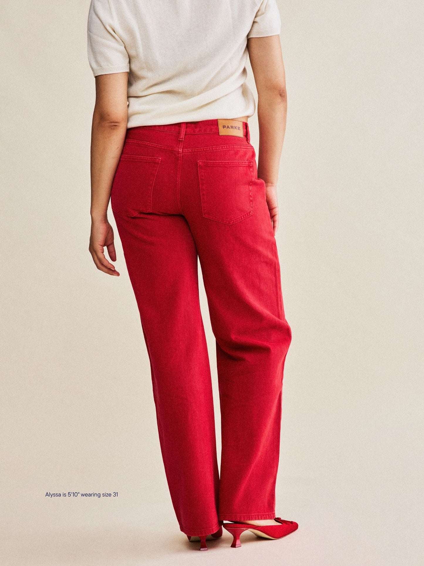 girl wearing classic straight jeans -washed red