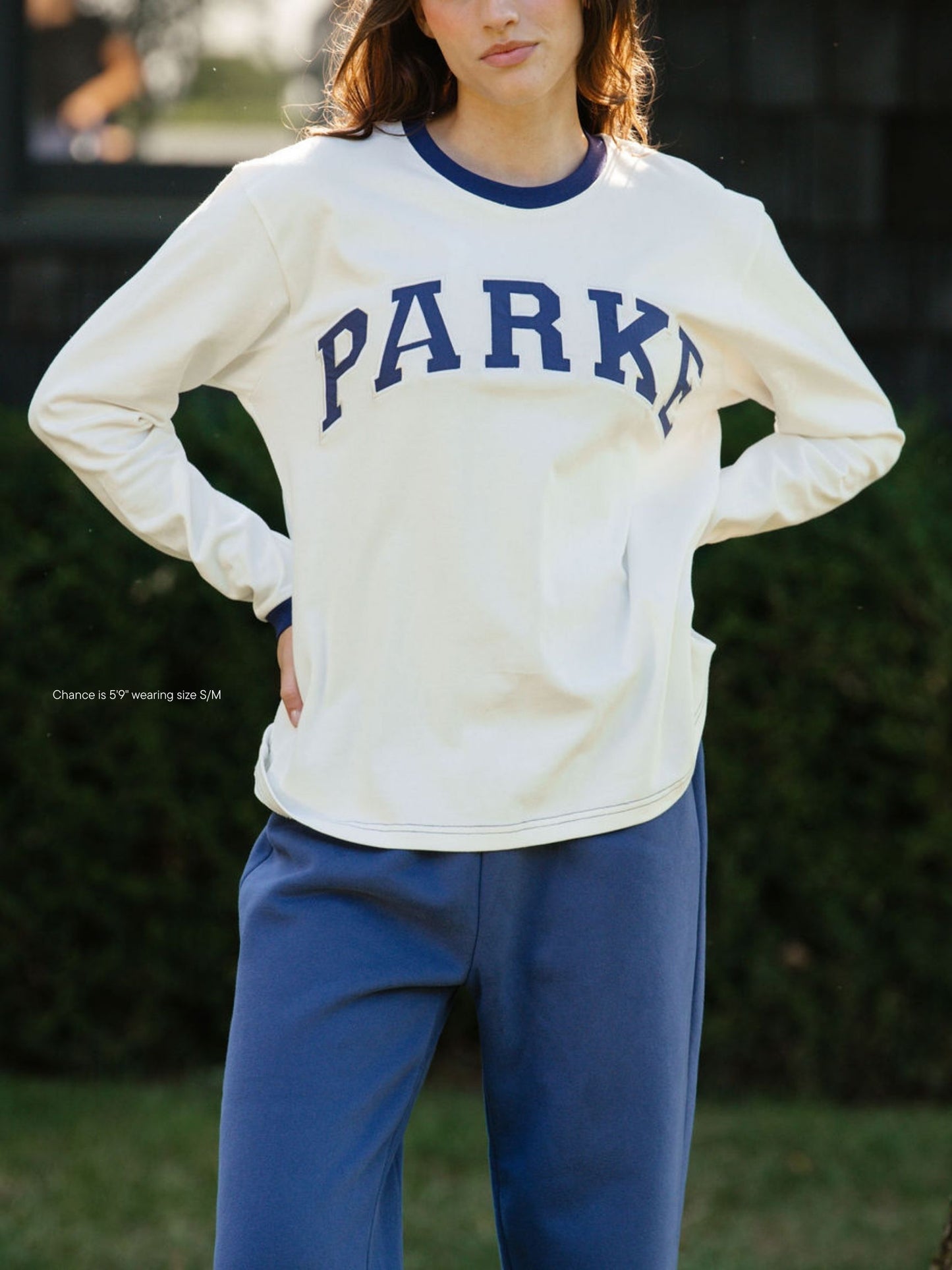 girl wearing varsity long sleeve -crown blue