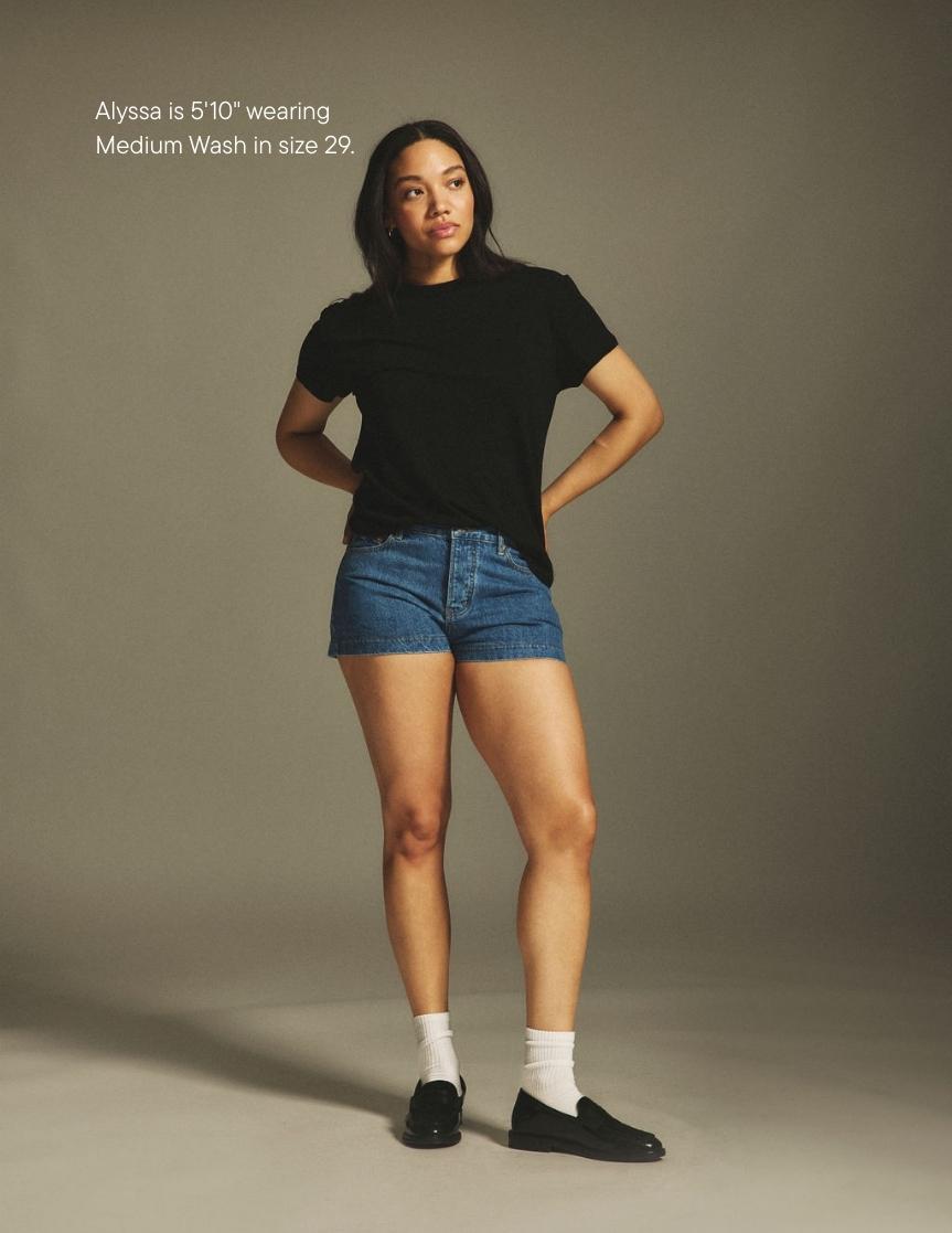 girl wearing denim mini shorts -medium wash