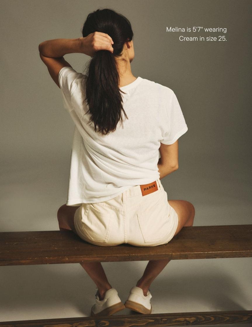 girl wearing denim mini shorts -cream