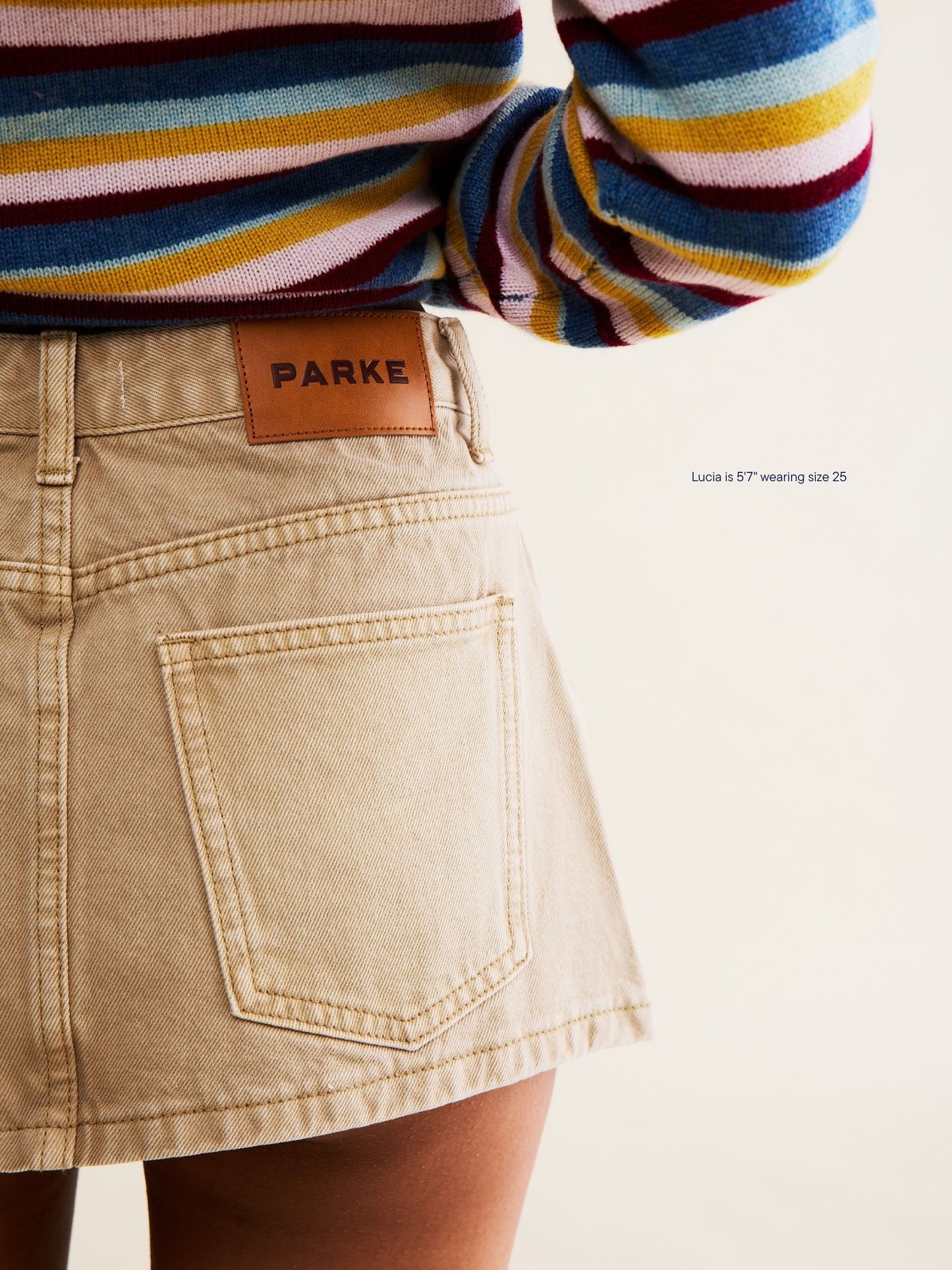 girl wearing denim mini skirt -camel