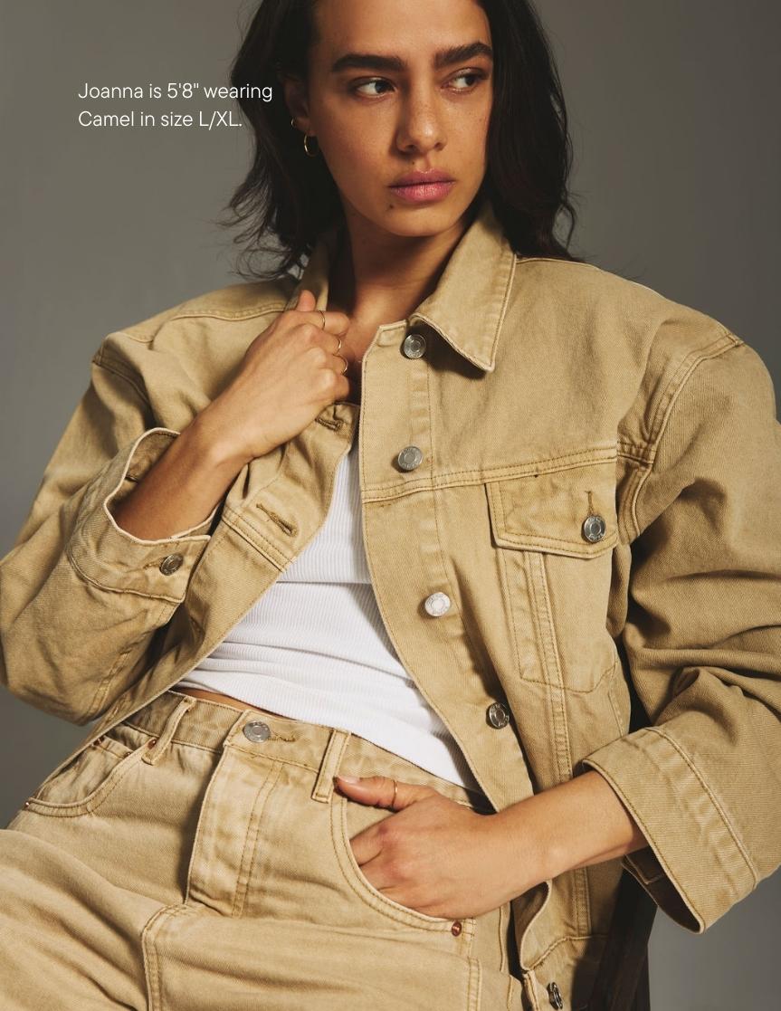 girl wearing oversized jean jacket -camel