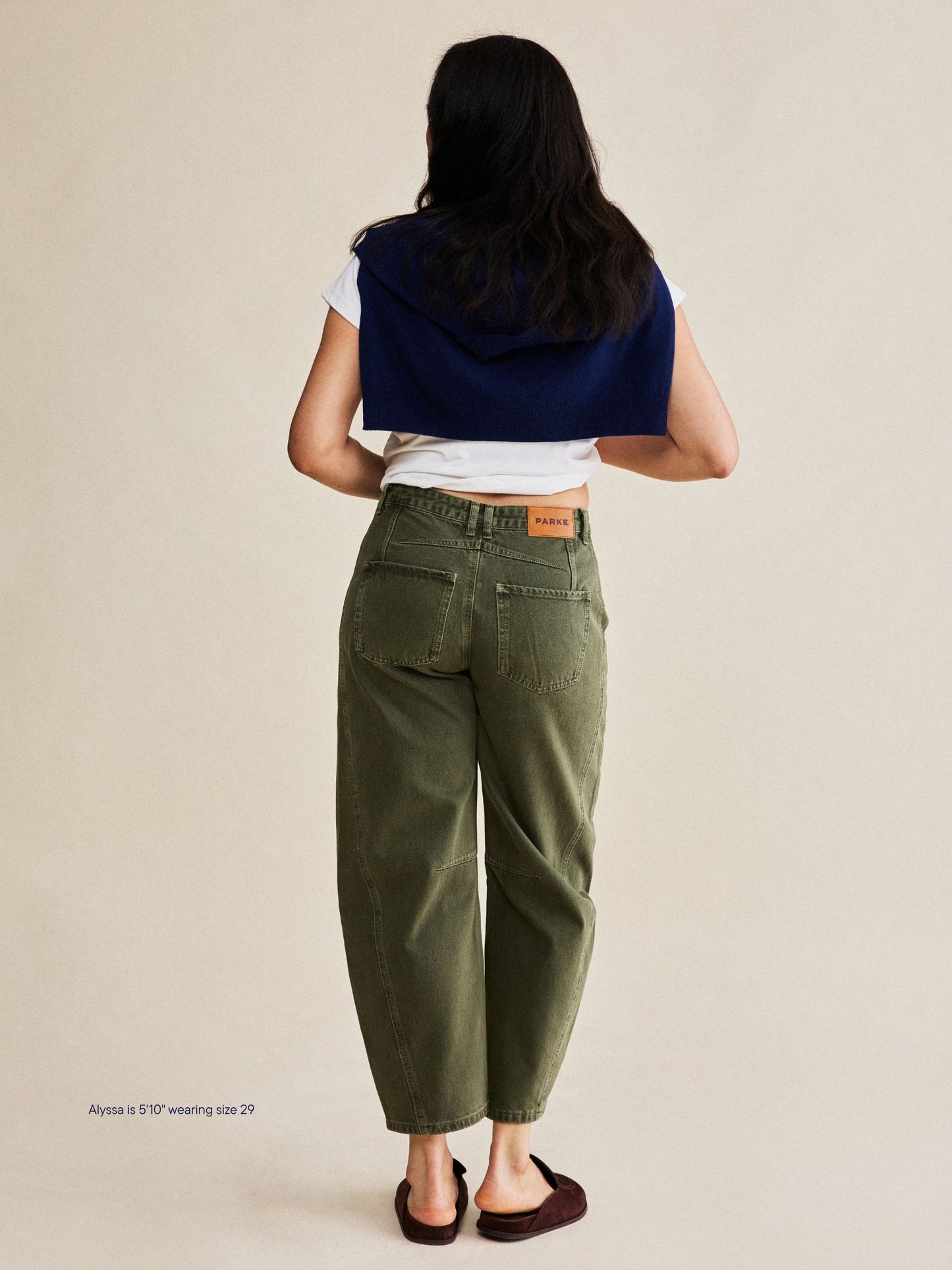 girl wearing horseshoe jeans -olive