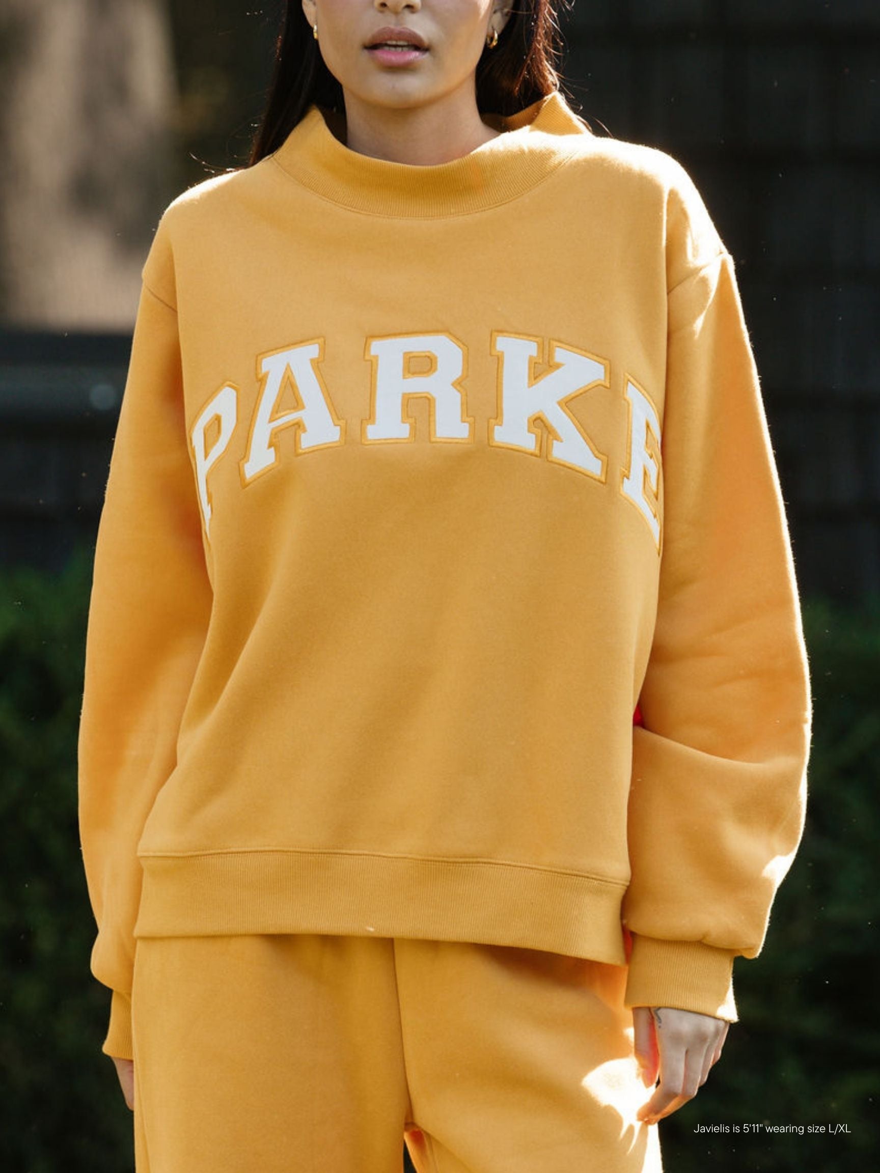 girl wearing hometown varsity mockneck flat -apricot + white
