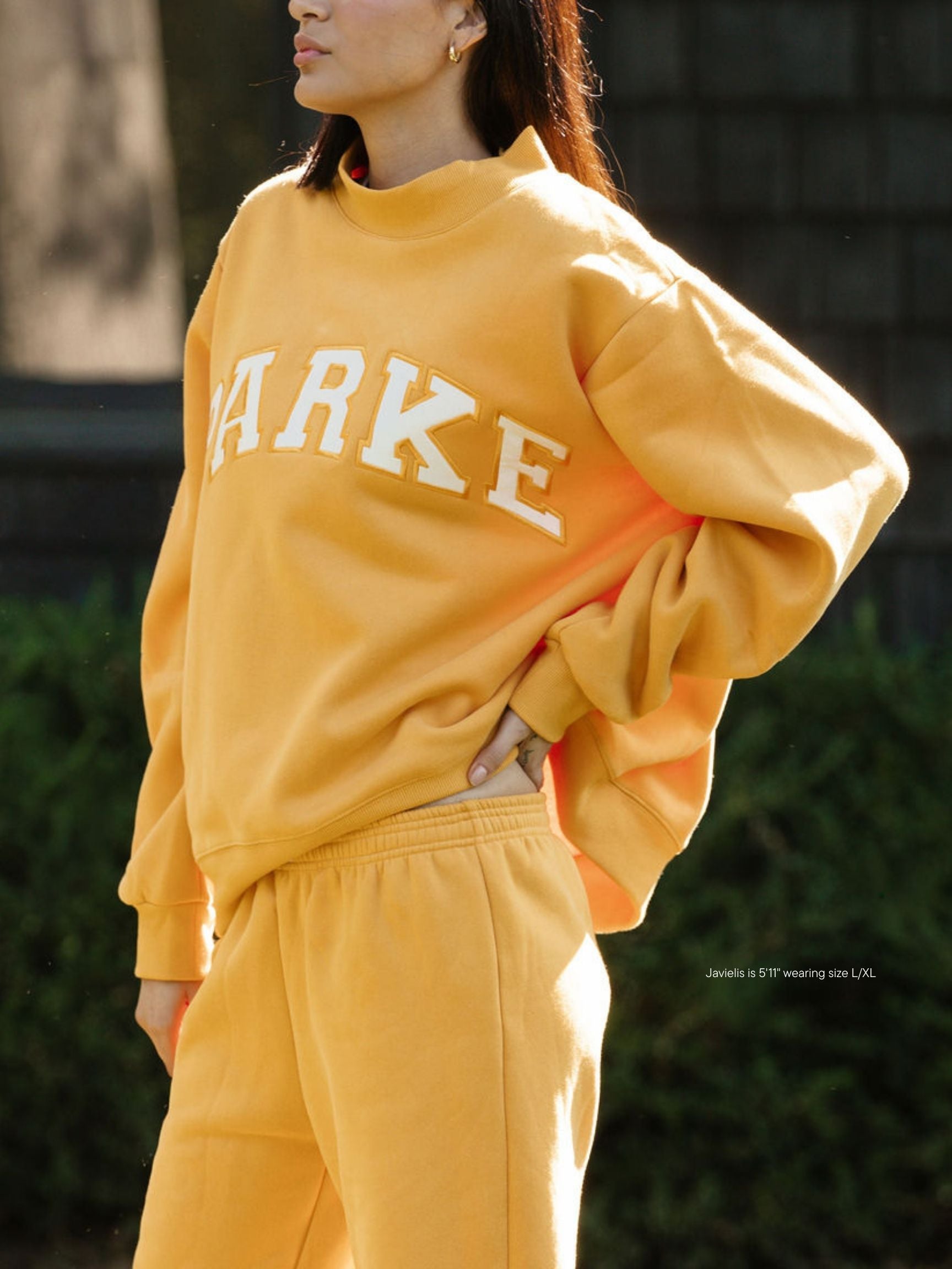 girl wearing hometown varsity mockneck flat -apricot + white