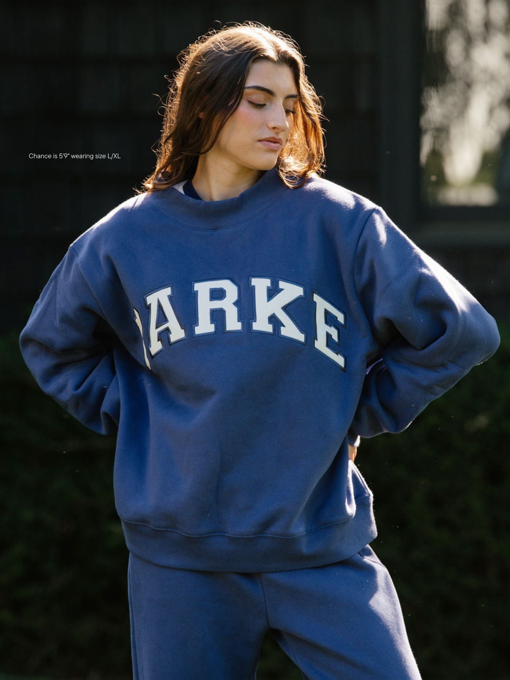 girl wearing hometown varsity mockneck flat -crown blue + white