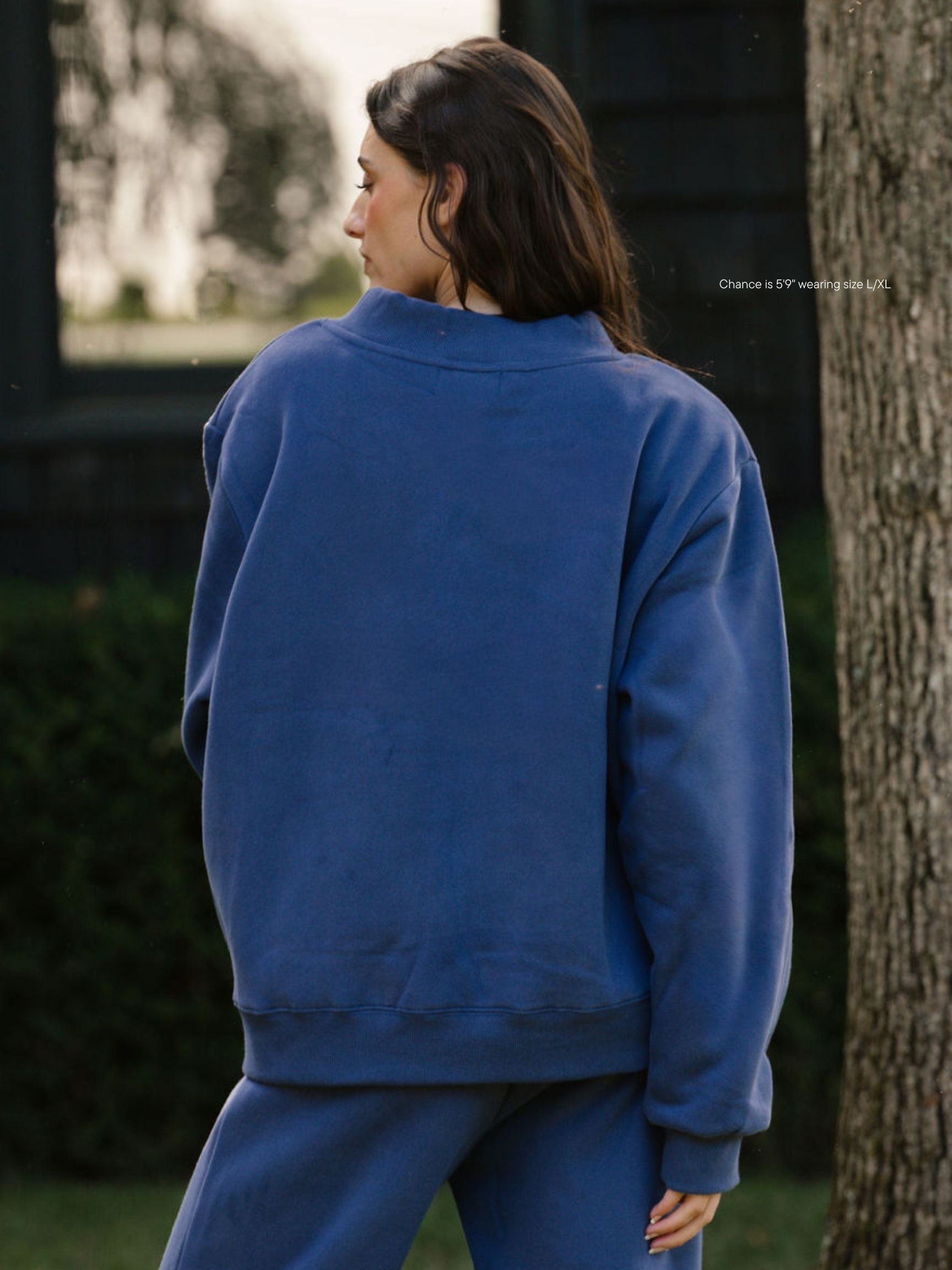 girl wearing hometown varsity mockneck flat -crown blue + white