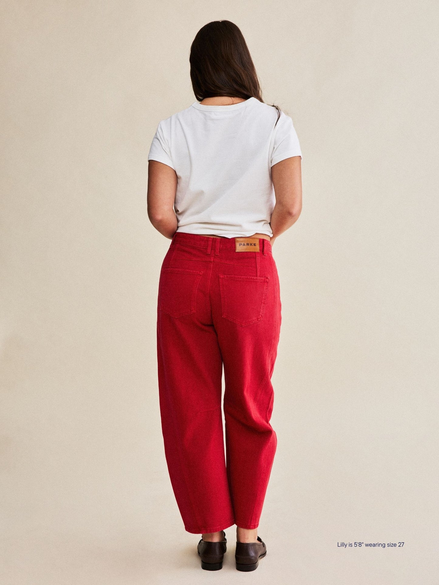 girl wearing horseshoe jeans -washed red