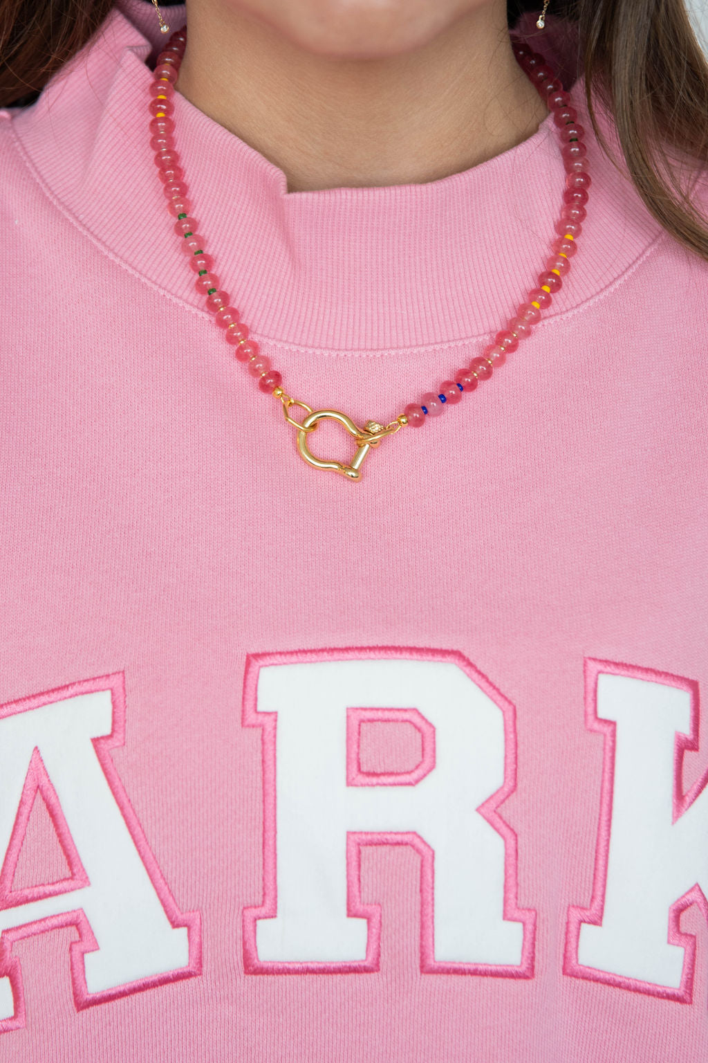 girl wearing spicy dan necklace -apple