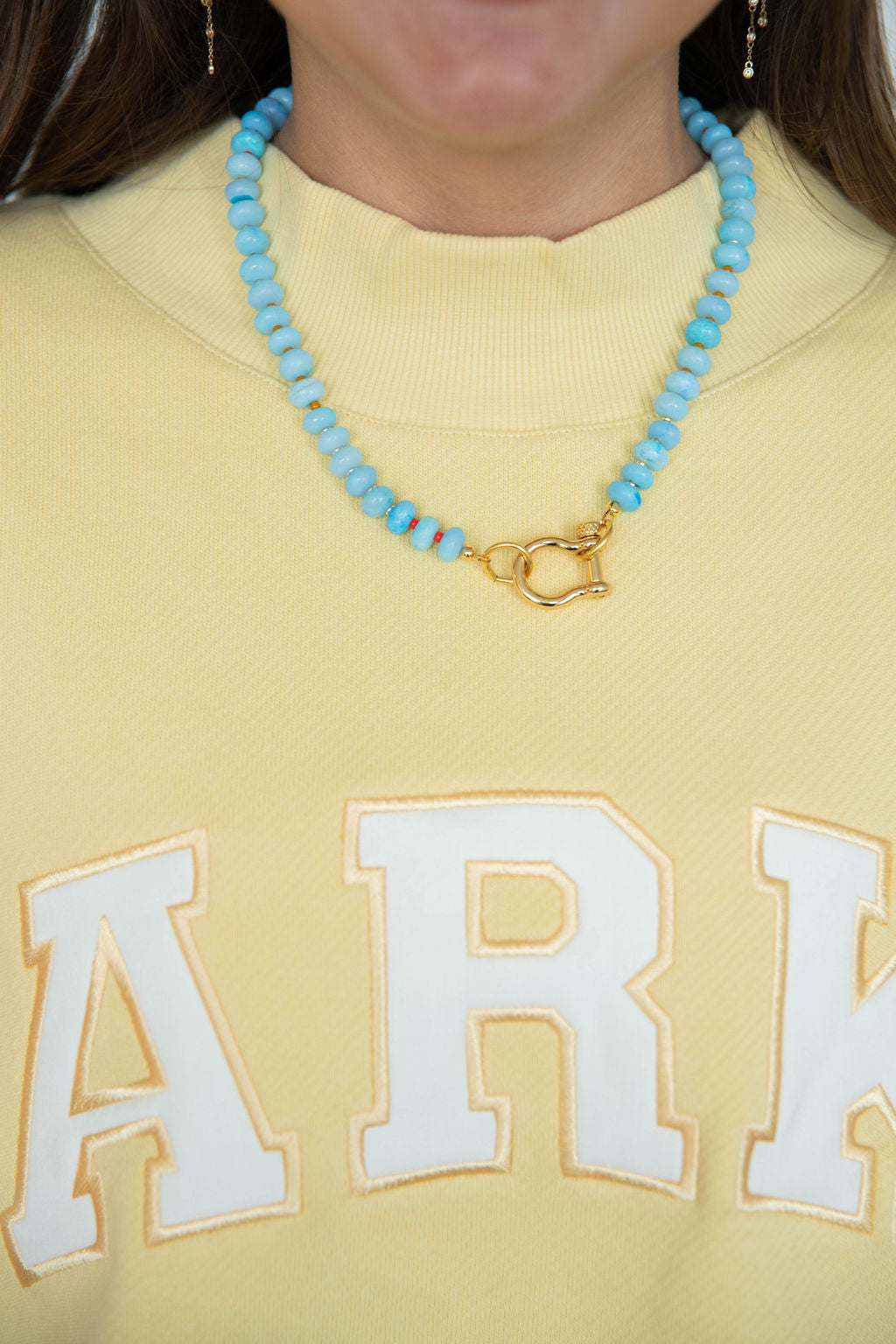 girl wearing spicy dan necklace -sky