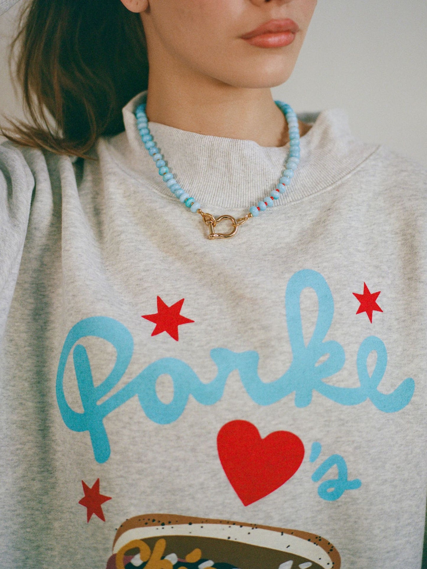 girl wearing spicy dan necklace -sky