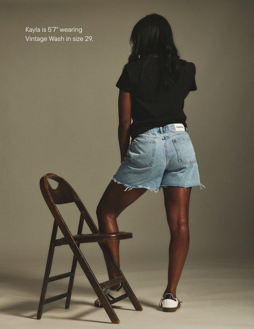 girl wearing long baggy shorts -vintage wash