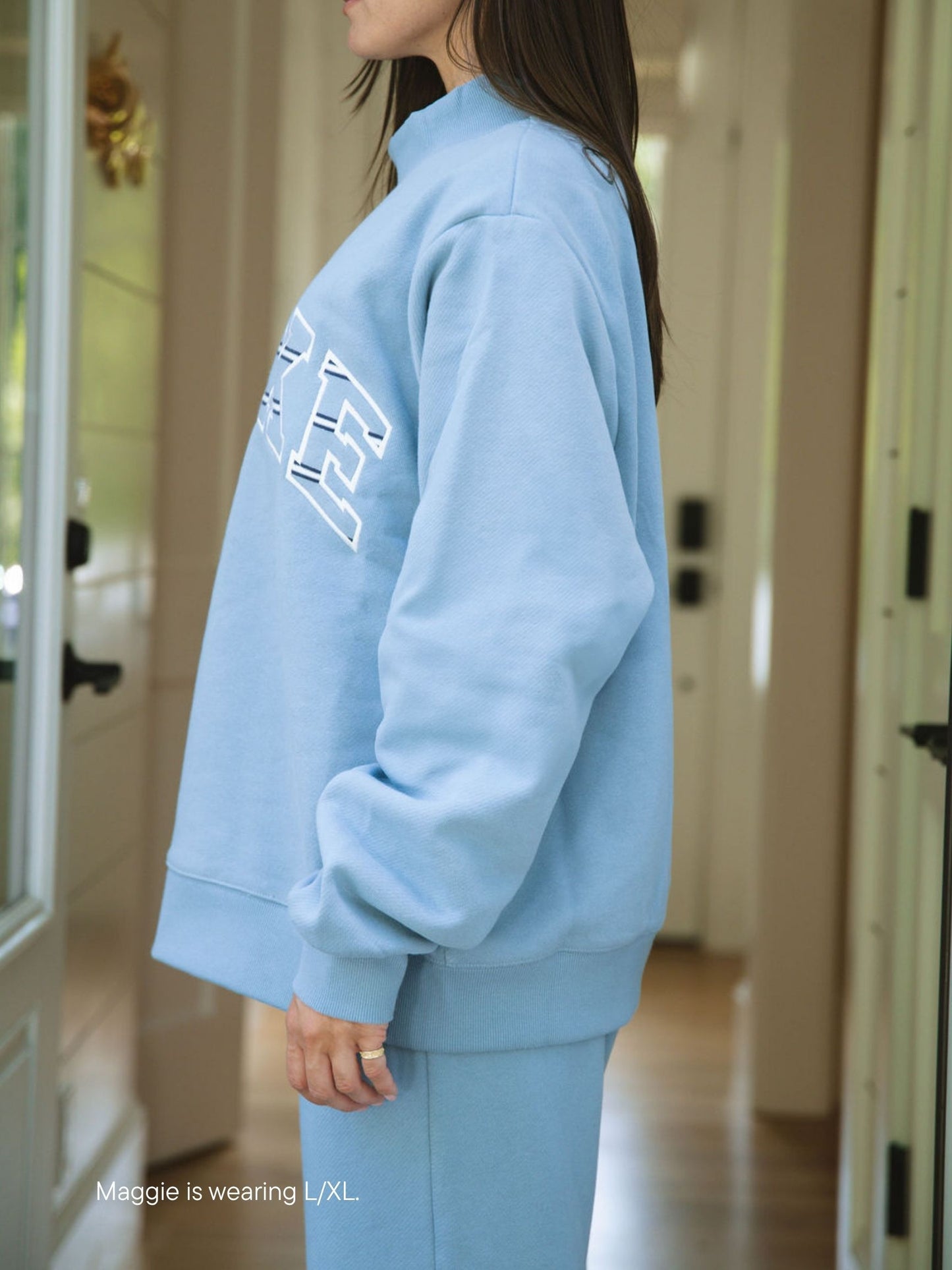 girl wearing Maggie & Emma Heritage Varsity Mockneck -sky