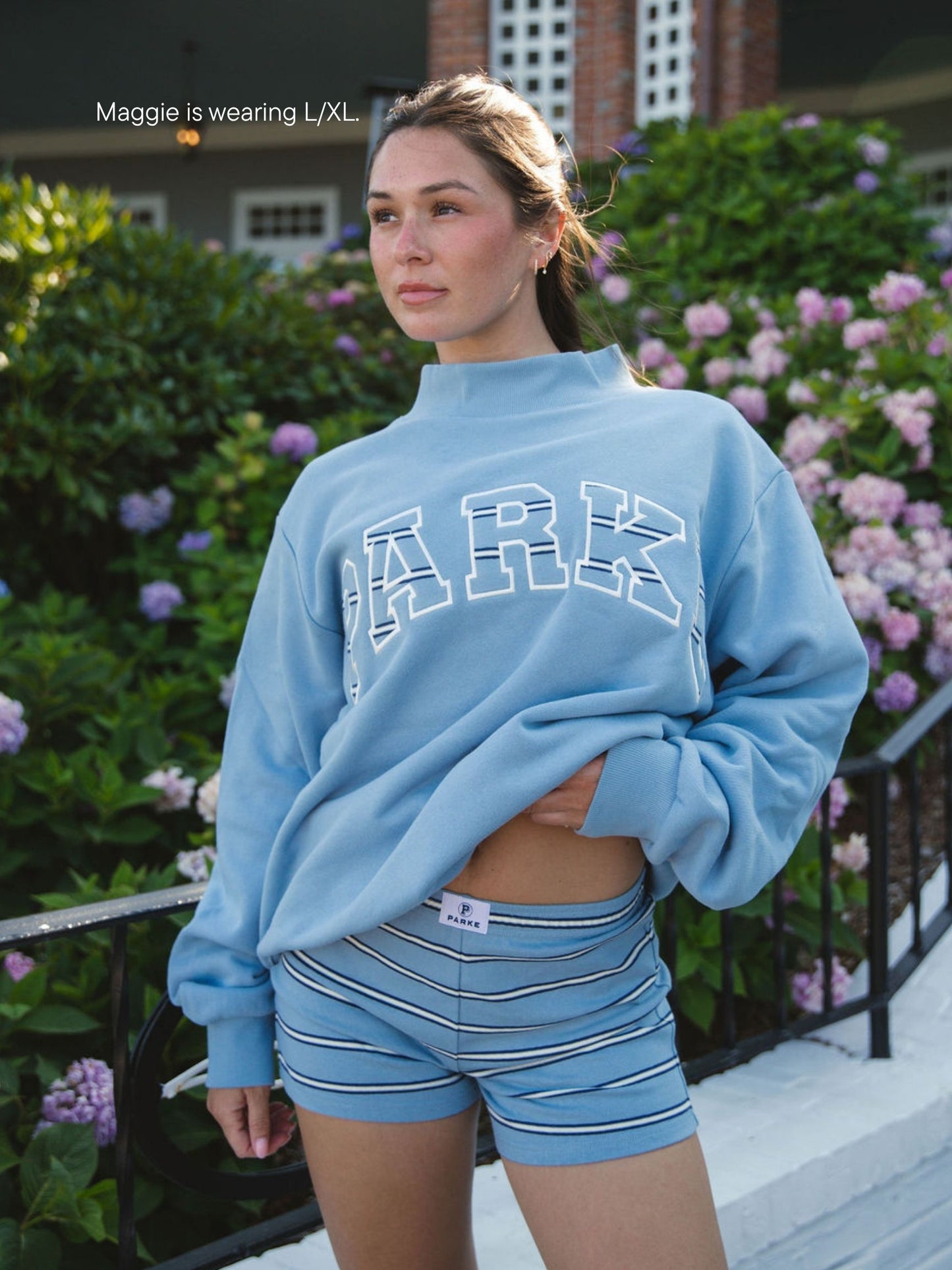 girl wearing Maggie & Emma Heritage Varsity Mockneck -sky