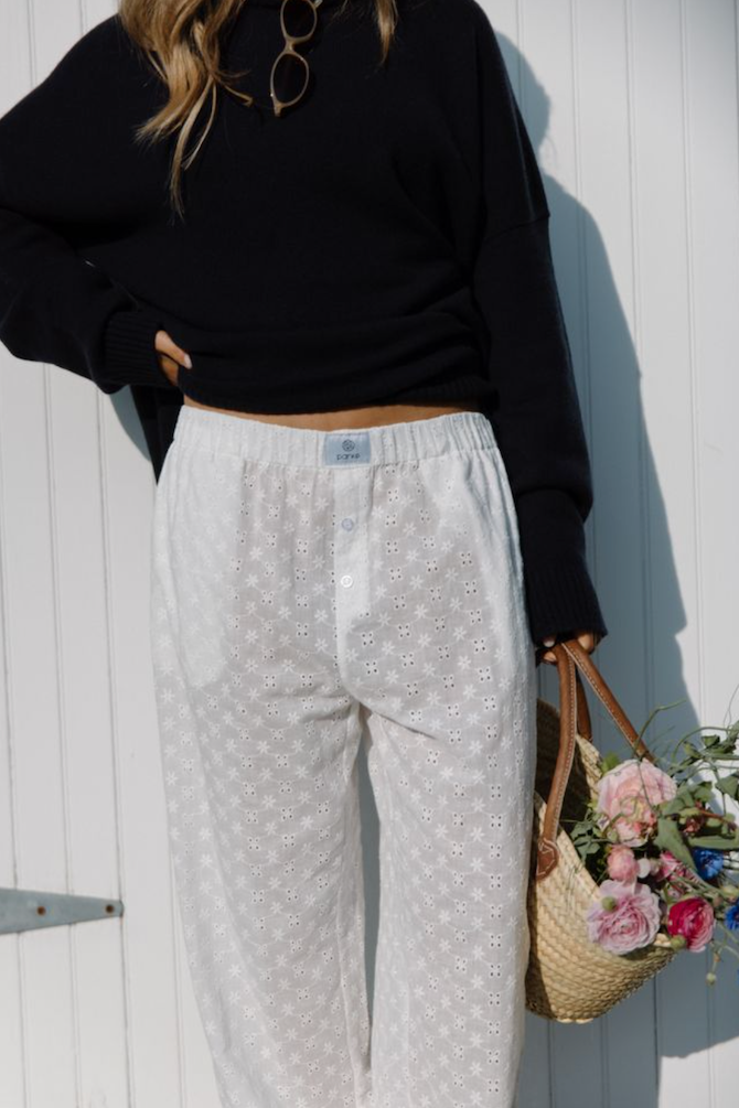 model wearing eyelet boxer pant in front of door -eyelet white