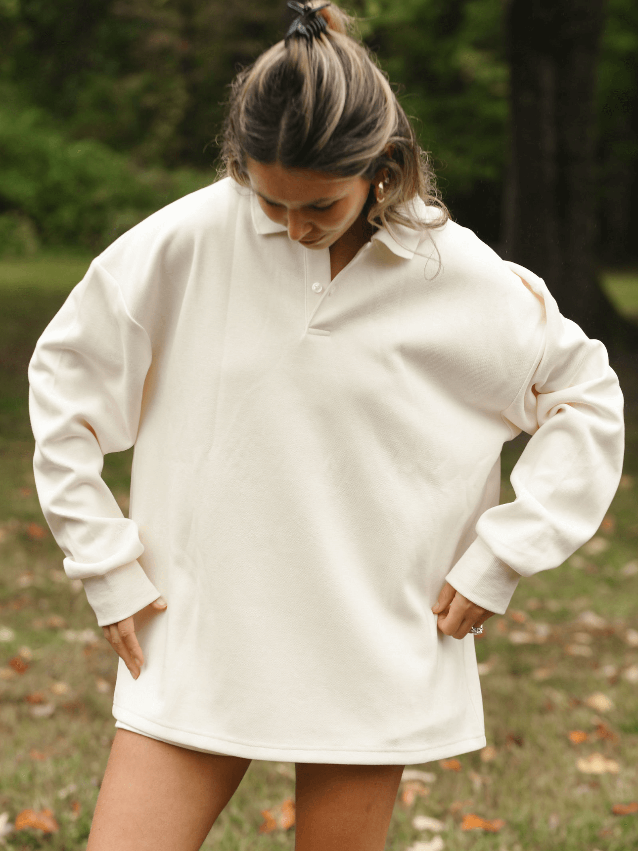 girl showing front of long sleeve polo -
cream