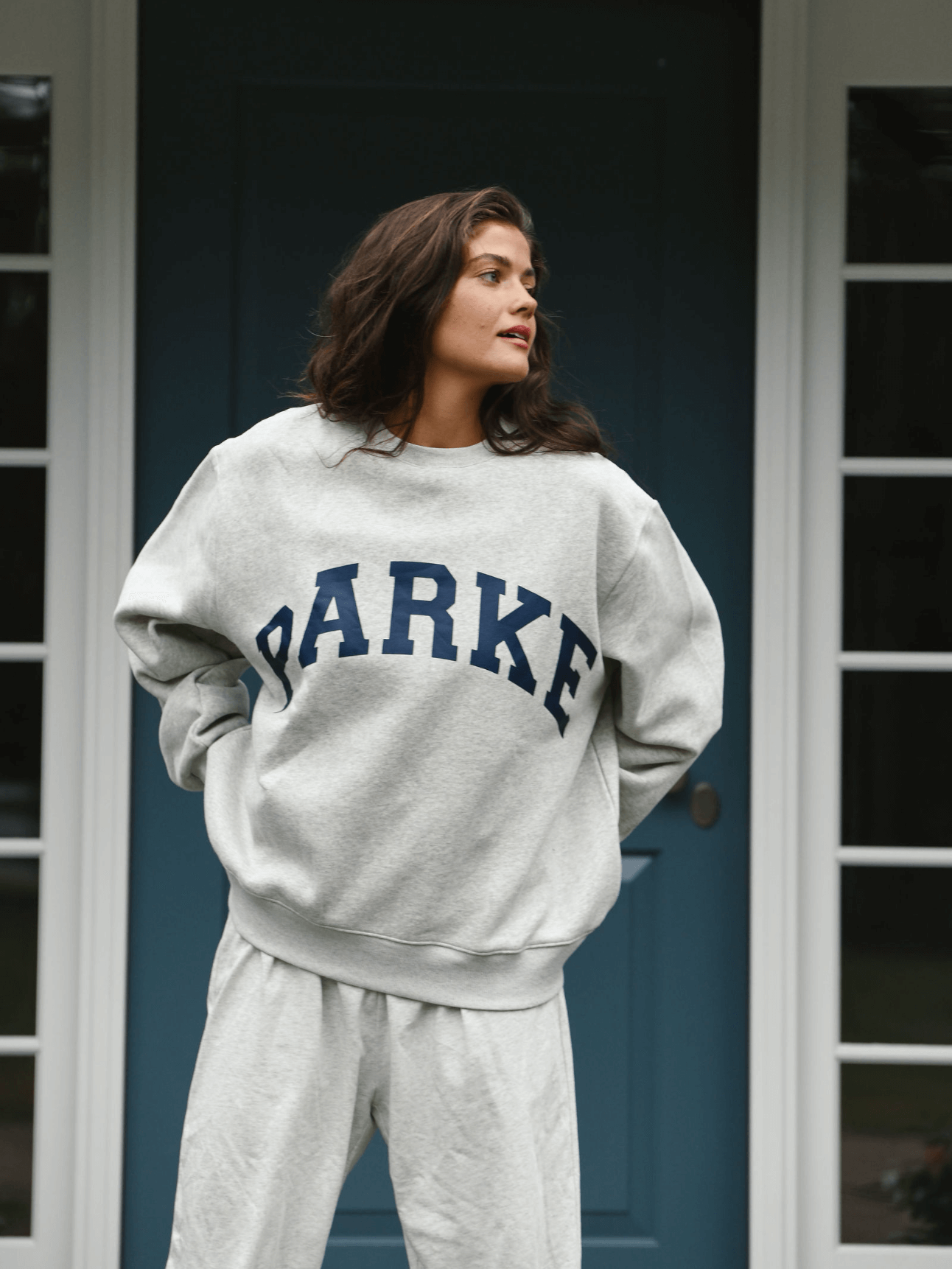 model wearing varsity crewneck sweatshirt -classic grey + navy