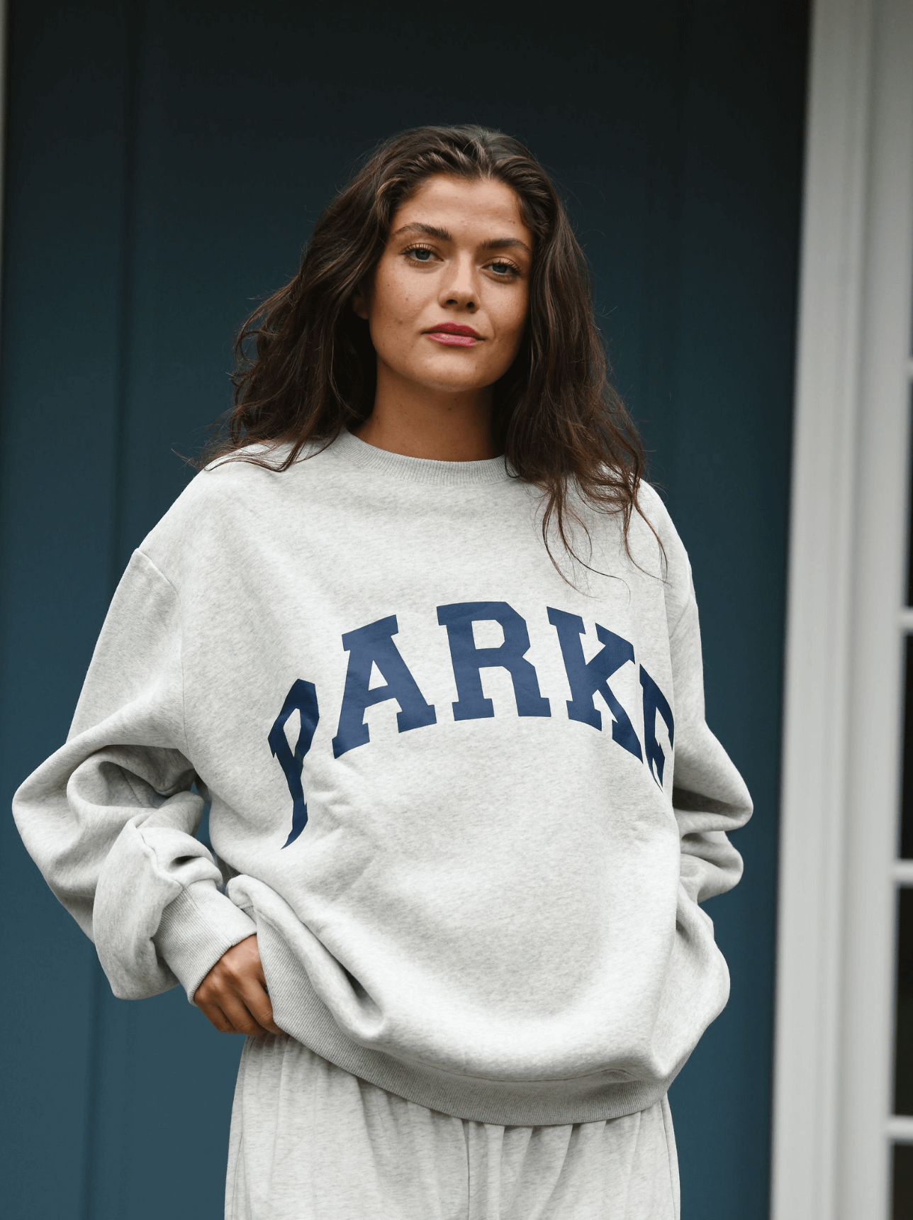 model wearing varsity crewneck sweatshirt -classic grey + navy