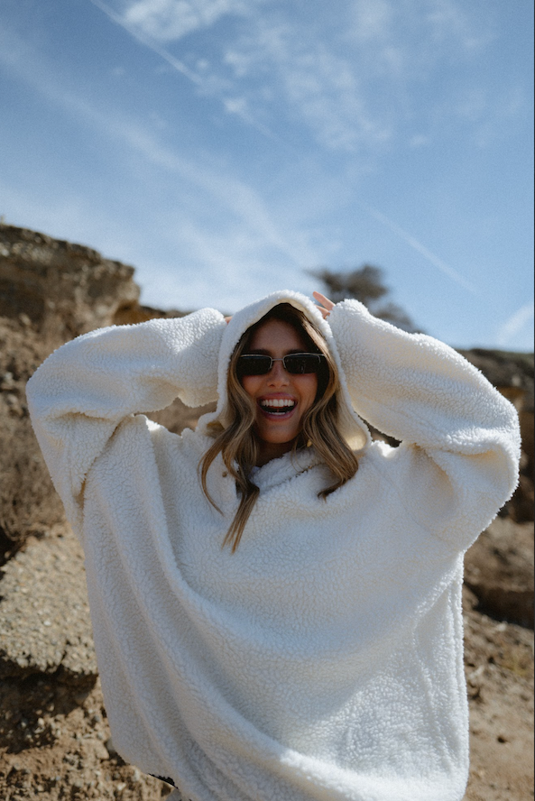 girl wearing cream hooded fleece with hood on - cream
