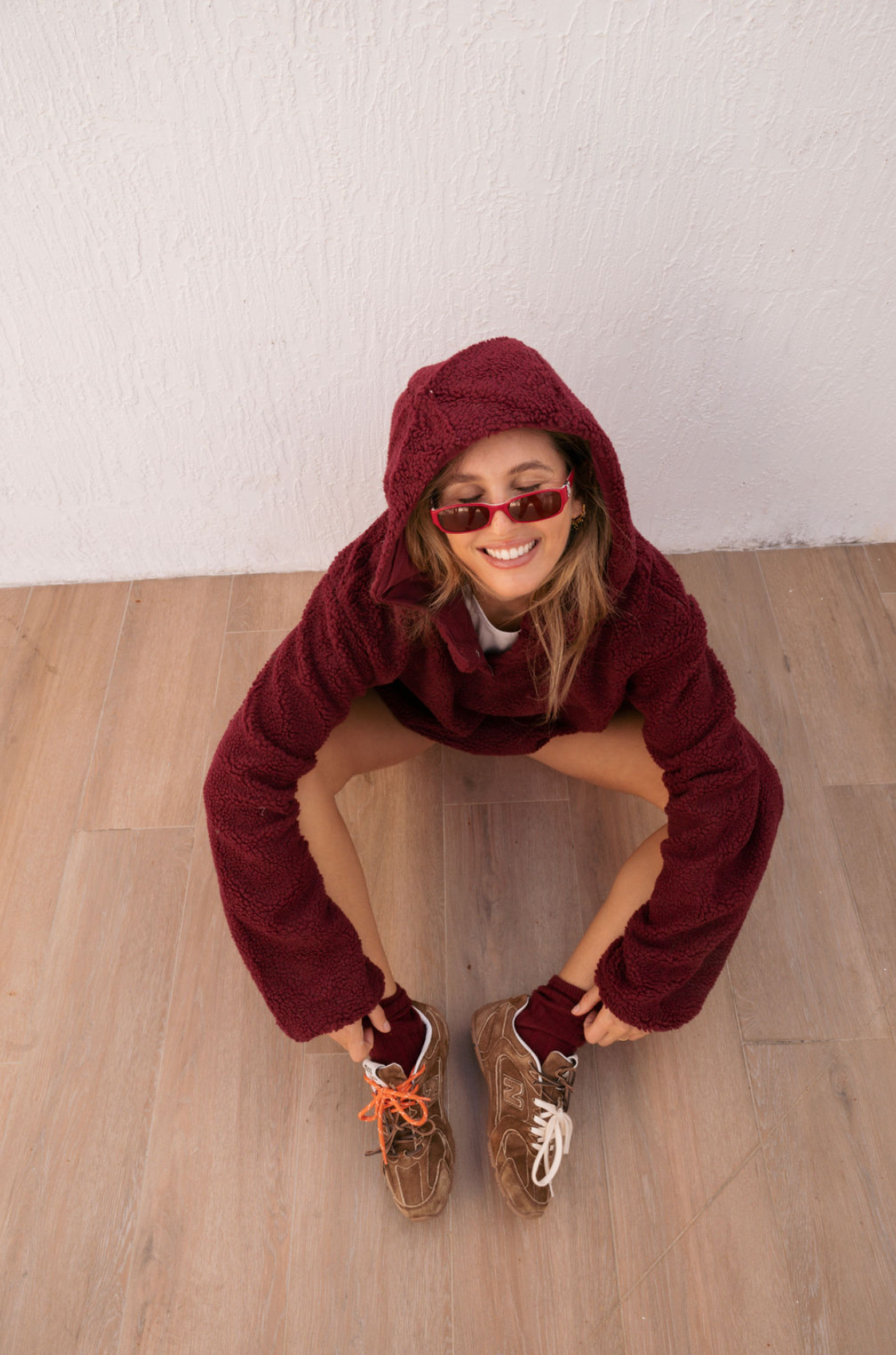 girl sitting wearing maroon hooded fleece - maroon
